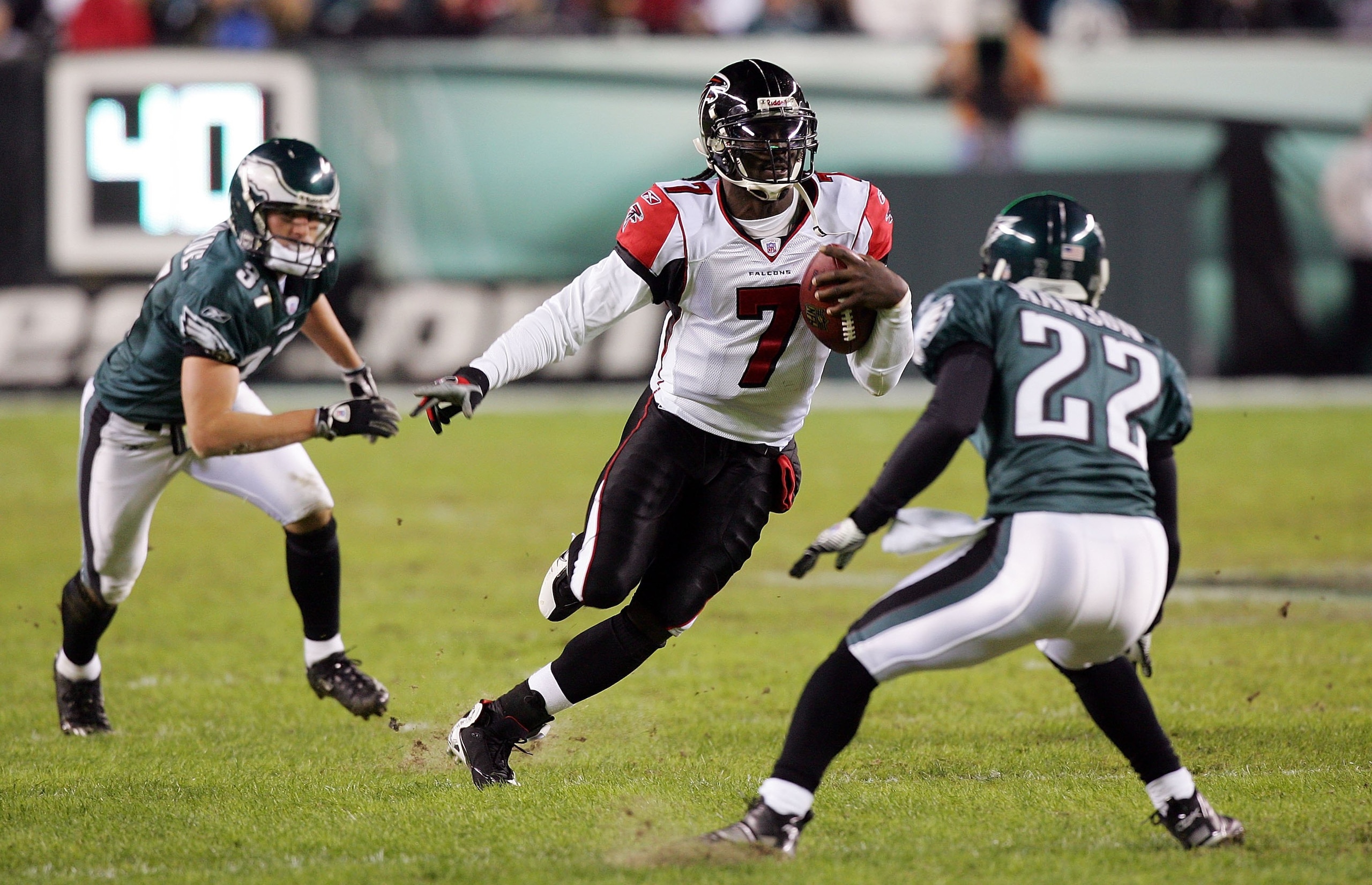 PHILADELPHIA - DECEMBER 31: Michael Vick #7 of the Atlanta Falcons runs the ball against Sean Considine #37 and Joselio Hanson #22 of the Philadelphia Eagles in NFL action December 31, 2006 at Lincoln Financial Field in Philadelphia, Pennsylvania. (Phot PHILADELPHIA - DECEMBER 31: Michael Vick #7 of the Atlanta Falcons runs the ball against Sean Considine #37 and Joselio Hanson #22 of the Philadelphia Eagles in NFL action December 31, 2006 at Lincoln Financial Field in Philadelphia, Pennsylvania. (Phot