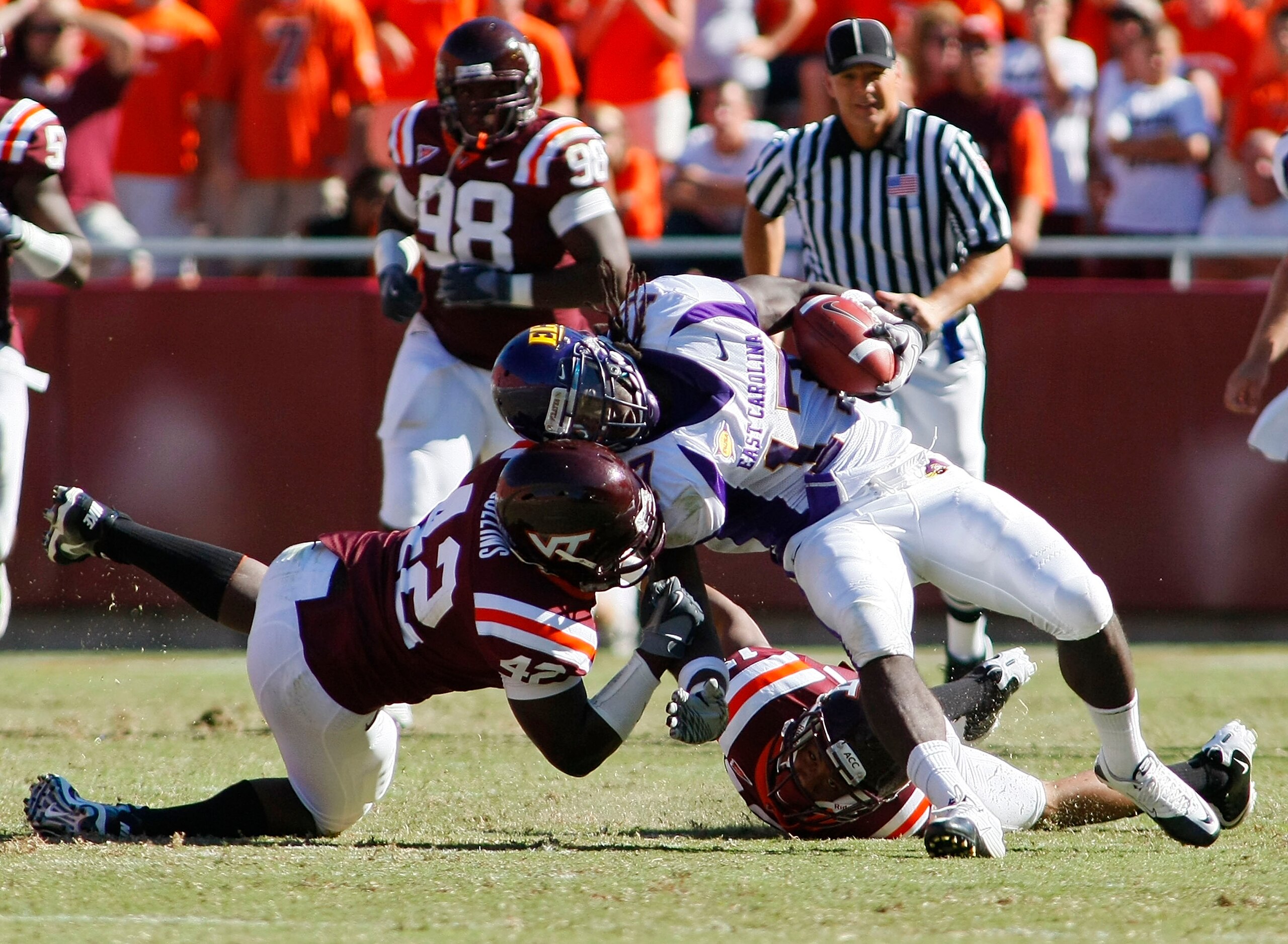 BLACKSBURG, VA - SEPTEMBER 18:  Defensive end J.R. Collins #42 and  cornerback Kyle Fuller #17 of the Virginia Tech Hokies tackle wide receiver Dwayne Harris #17 of the East Carolina Pirates at Lane Stadium on September 18, 2010 in Blacksburg, Virginia.