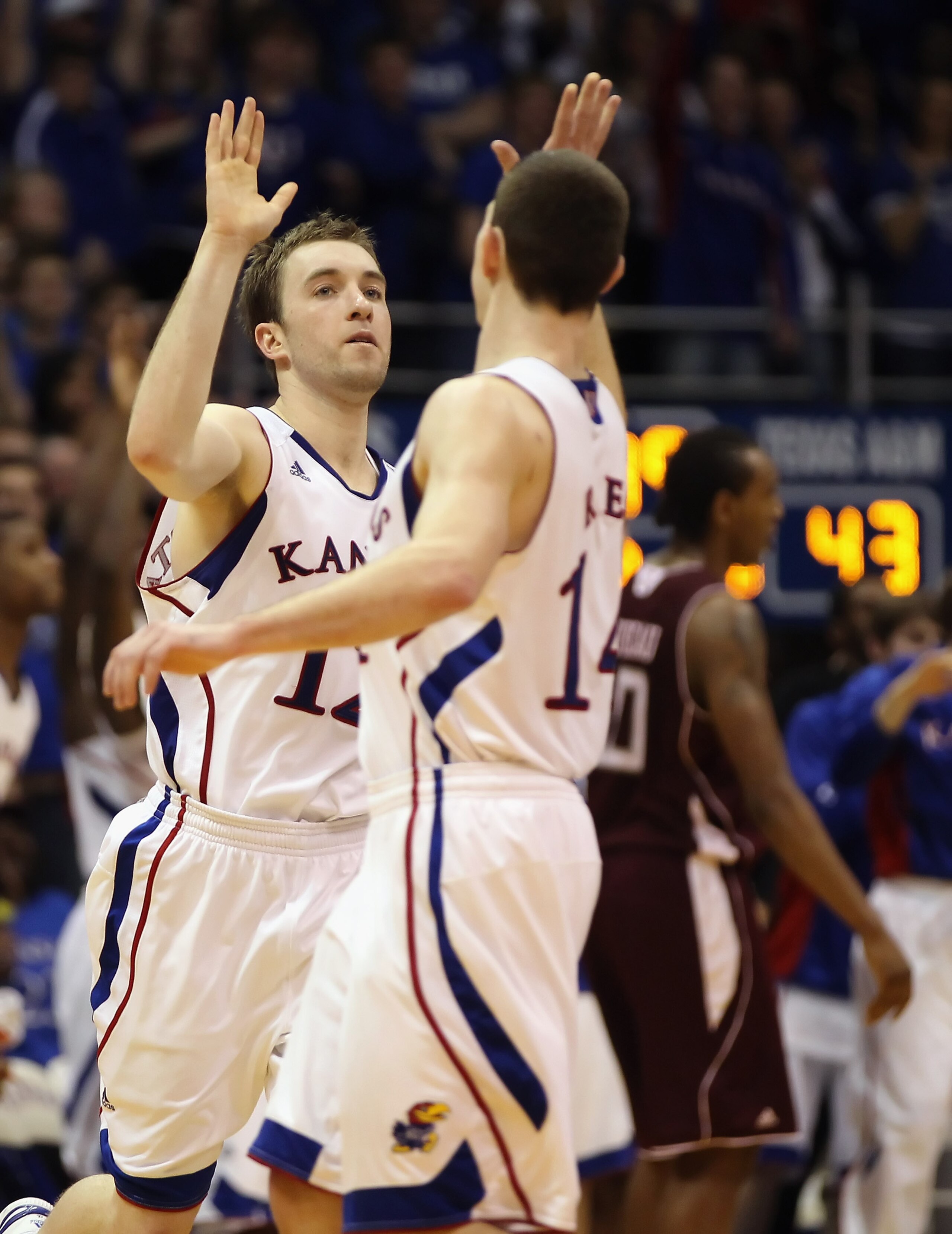 LAWRENCE, KS - MARCH 02:  Brady Morningstar #12 of the Kansas Jayhawks high-fives Tyrel Reed #14 after scoring during the game against the Texas A&M Aggies on March 2, 2011 at Allen Fieldhouse in Lawrence, Kansas.  (Photo by Jamie Squire/Getty Images)