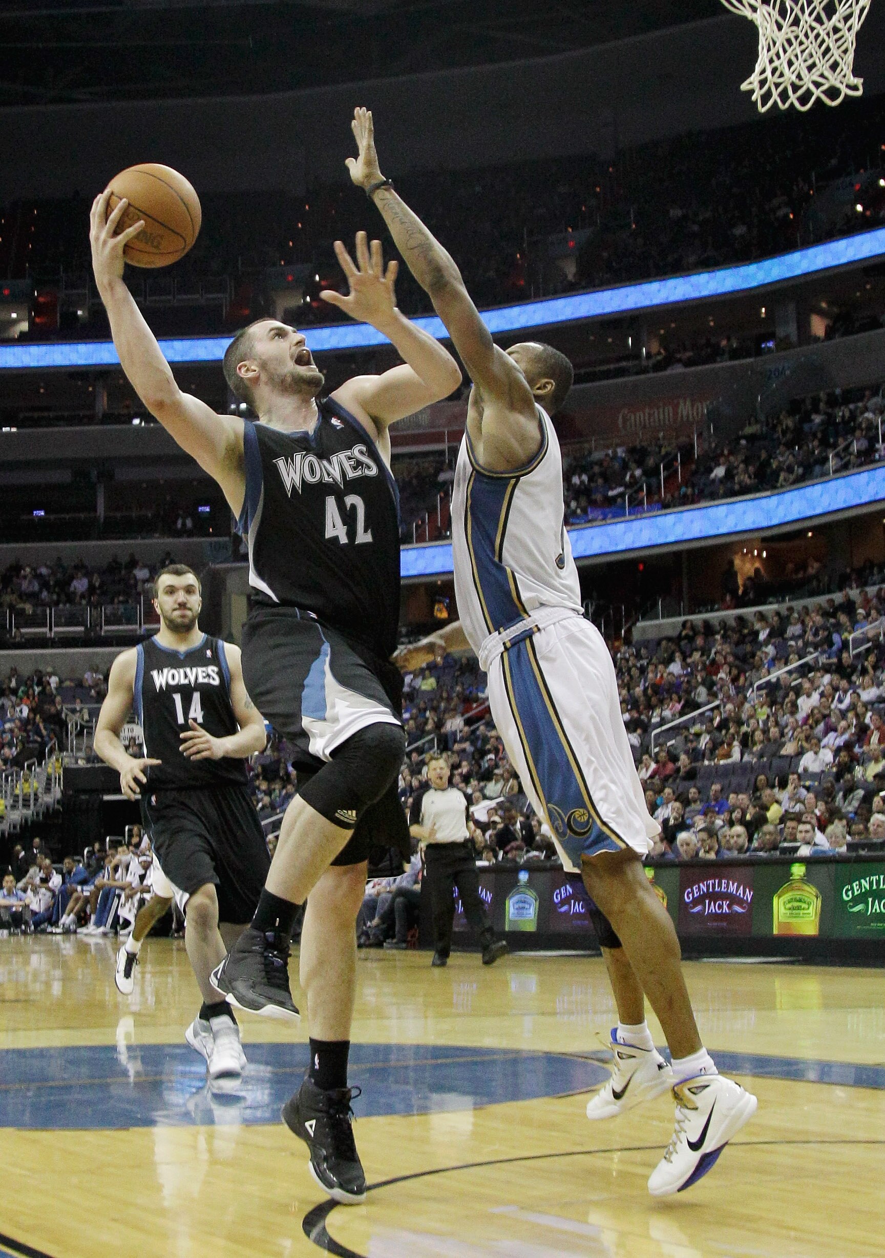 WASHINGTON, DC - MARCH 05:  Kevin Love #42 of the Minnesota Timberwolves puts up a shot over the defense of Rashard Lewis #9 of the Washington Wizards at the Verizon Center on March 5, 2011 in Washington, DC. NOTE TO USER: User expressly acknowledges and