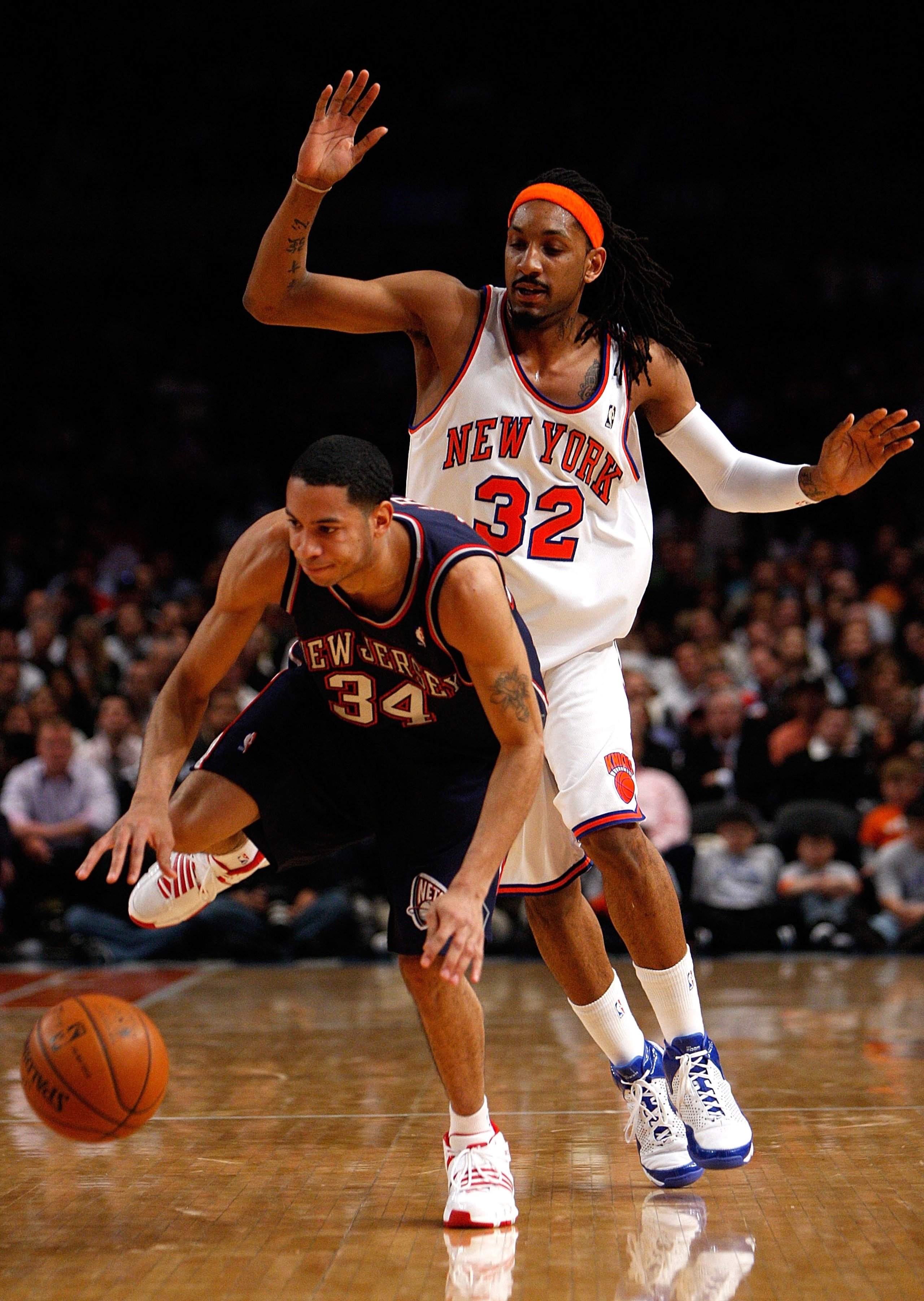 NEW YORK - MARCH 24:  Devin Harris #34 of the New Jersey Nets dribbles the ball downcourt under pressure from Renaldo Balkman #32 of the New York Knicks on March 24, 2008 at Madison Square Garden in New York City. NOTE TO USER: User expressly acknowledges