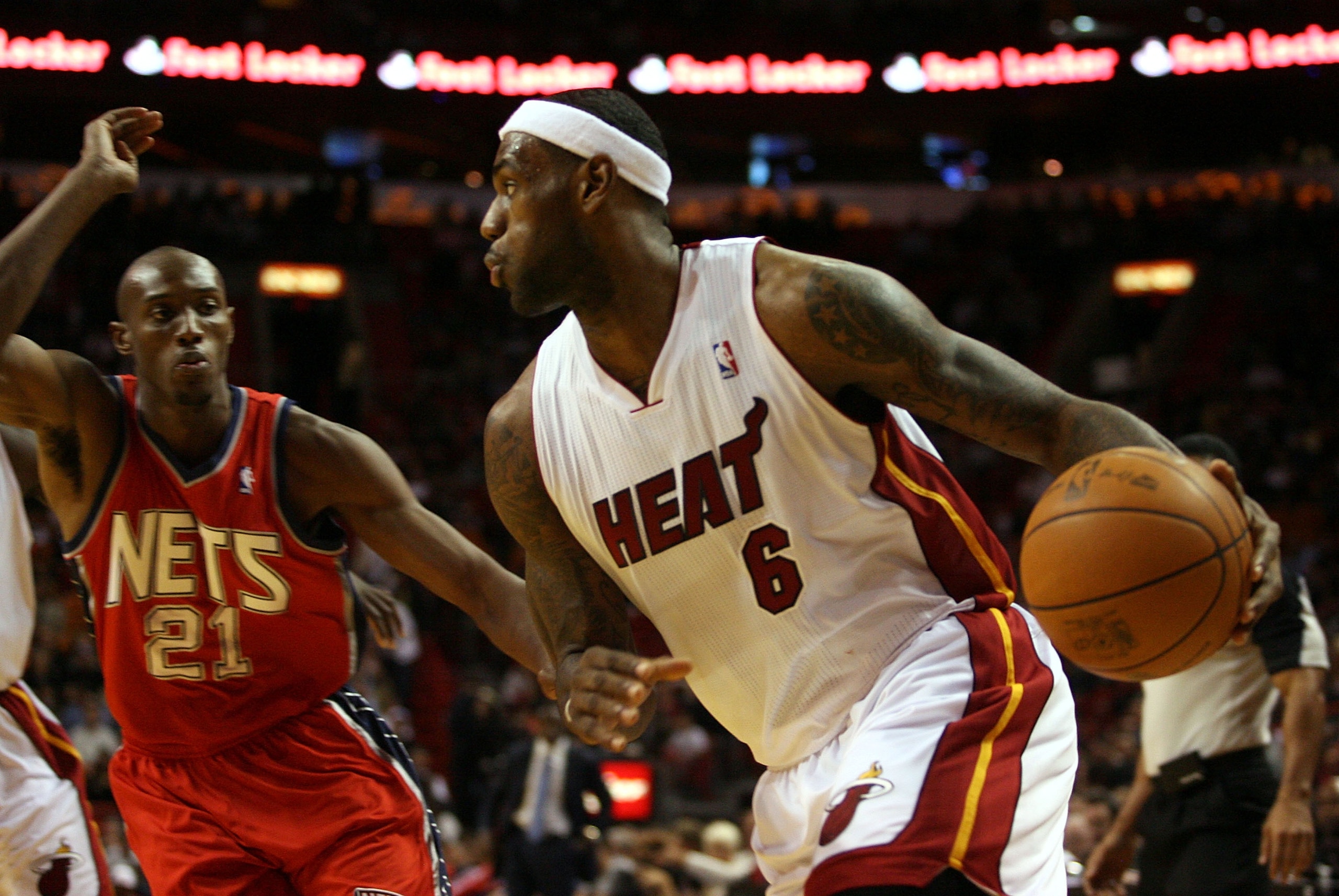MIAMI - NOVEMBER 06:  Forward LeBron James #6 of the Miami Heat drives againstTravis Outlaw #21  of the New Jersey Nets  at American Airlines Arena on November 6, 2010 in Miami, Florida. NOTE TO USER: User expressly acknowledges and agrees that, by downlo