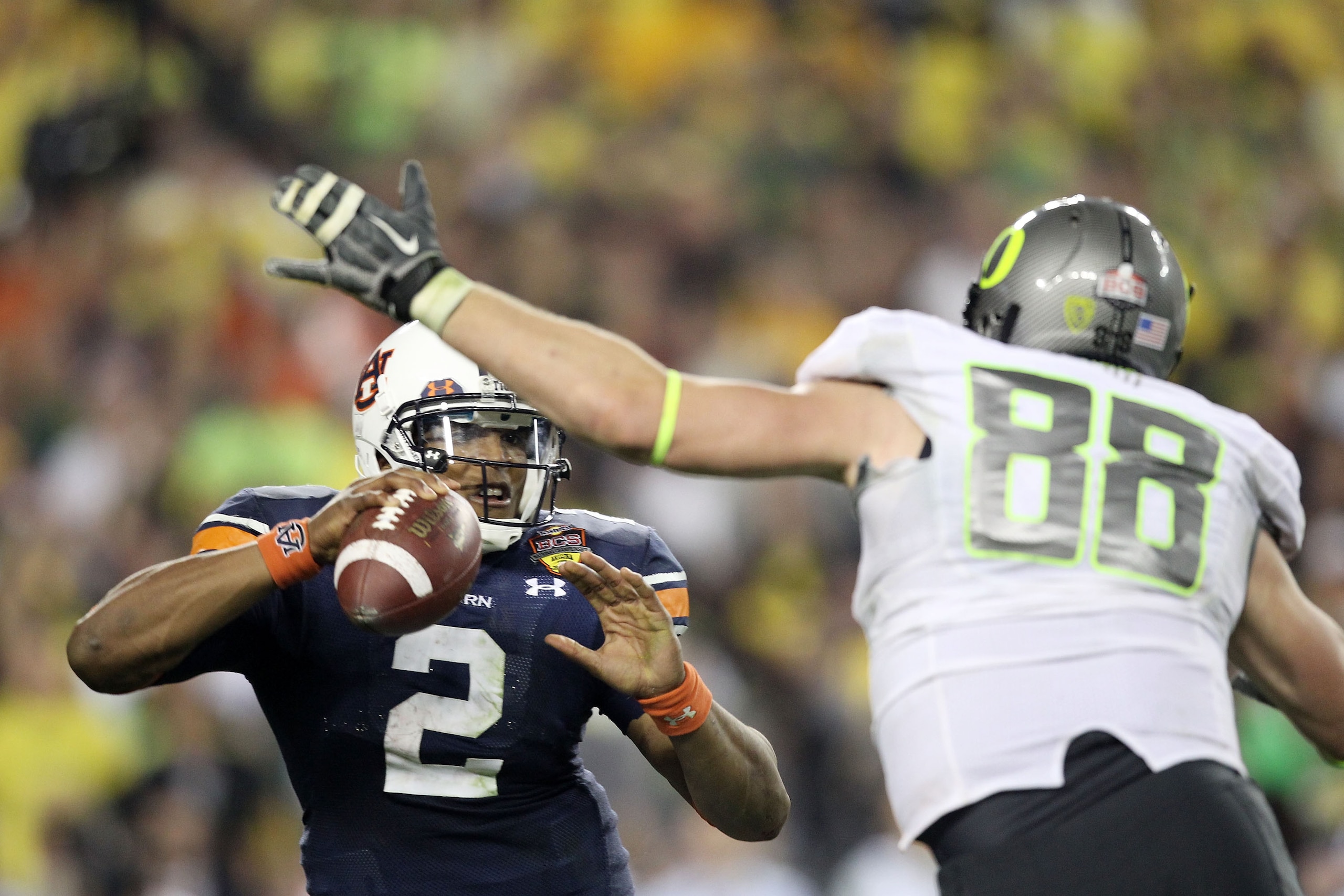 GLENDALE, AZ - JANUARY 10:  Cameron Newton #2 of the Auburn Tigers scrambles against Brandon Bair #88 of the Oregon Ducks during the Tostitos BCS National Championship Game at University of Phoenix Stadium on January 10, 2011 in Glendale, Arizona.  (Photo