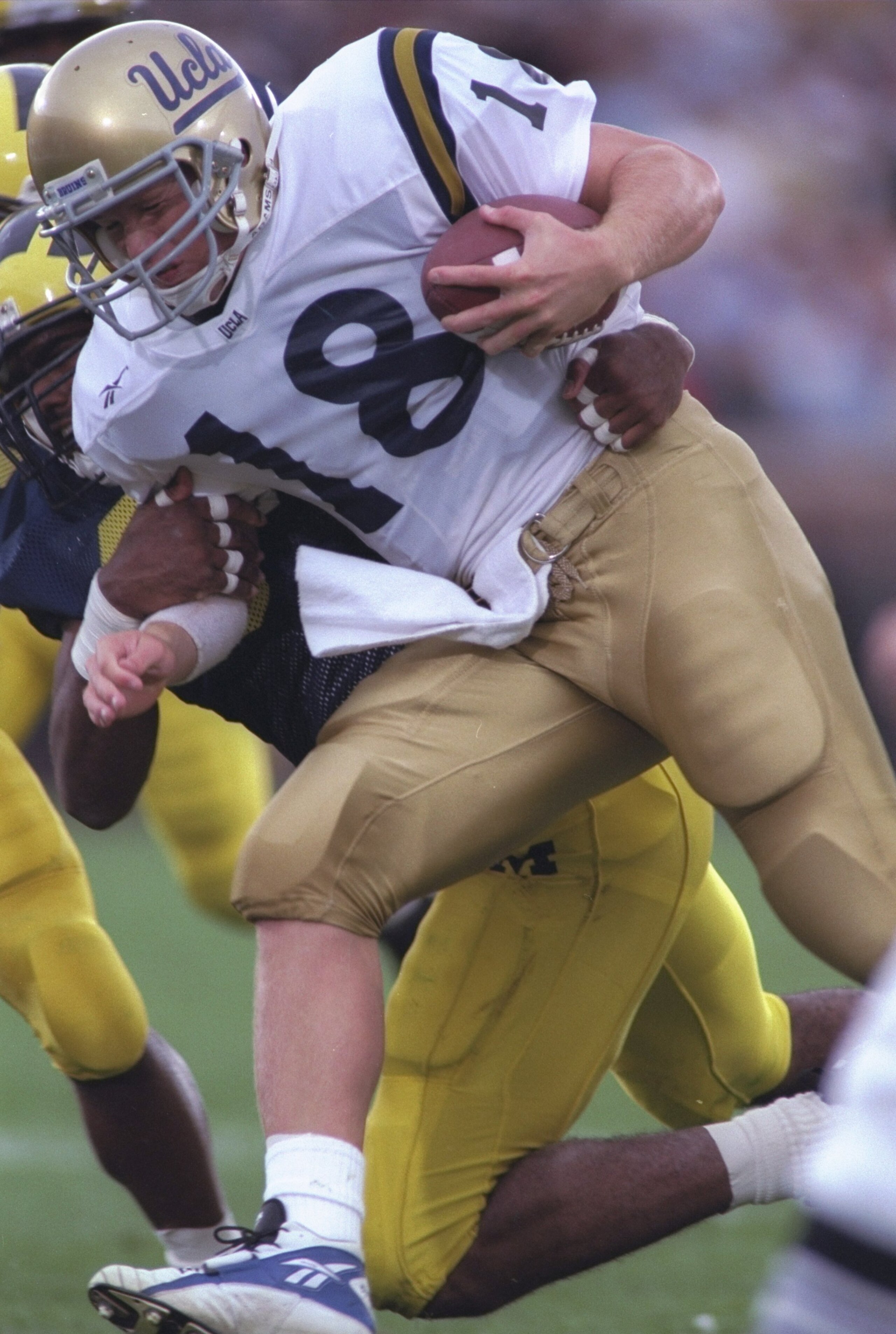 28 Sep 1996: Quarterback Cade McNown of the UCLA Bruins is tackled by David Bowens of the Michigan Wolverines during the Bruins 38-9 loss to the Michigan Wolverines at Michigan Stadium in Ann Arbor, Michigan. Mandatory Credit: Brian Bahr /Allsport 28 Sep 1996: Quarterback Cade McNown of the UCLA Bruins is tackled by David Bowens of the Michigan Wolverines during the Bruins 38-9 loss to the Michigan Wolverines at Michigan Stadium in Ann Arbor, Michigan. Mandatory Credit: Brian Bahr /Allsport
