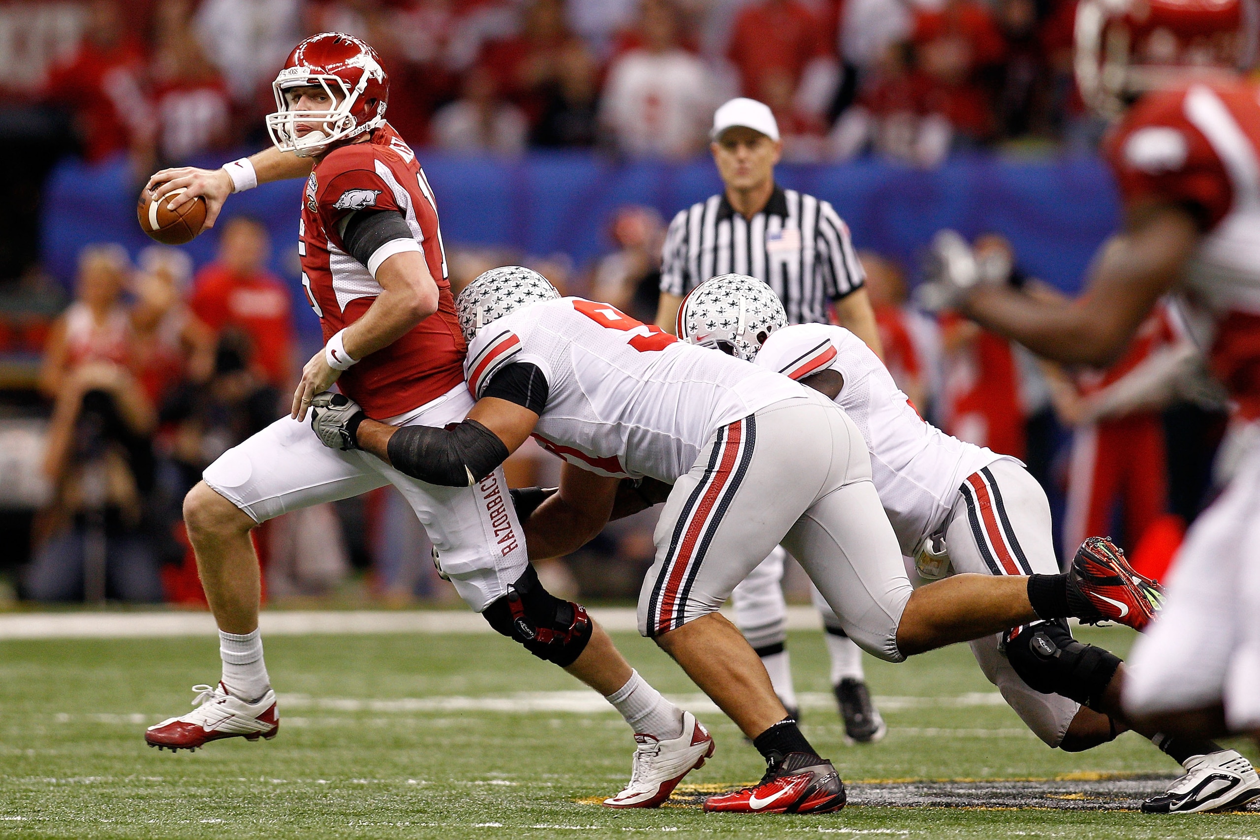 NEW ORLEANS, LA - JANUARY 04:  Ryan Mallett #15 of the Arkansas Razorbacks looks to pass in the first half under pressure from the Ohio State Buckeyes defense during the Allstate Sugar Bowl at the Louisiana Superdome on January 4, 2011 in New Orleans, Lou