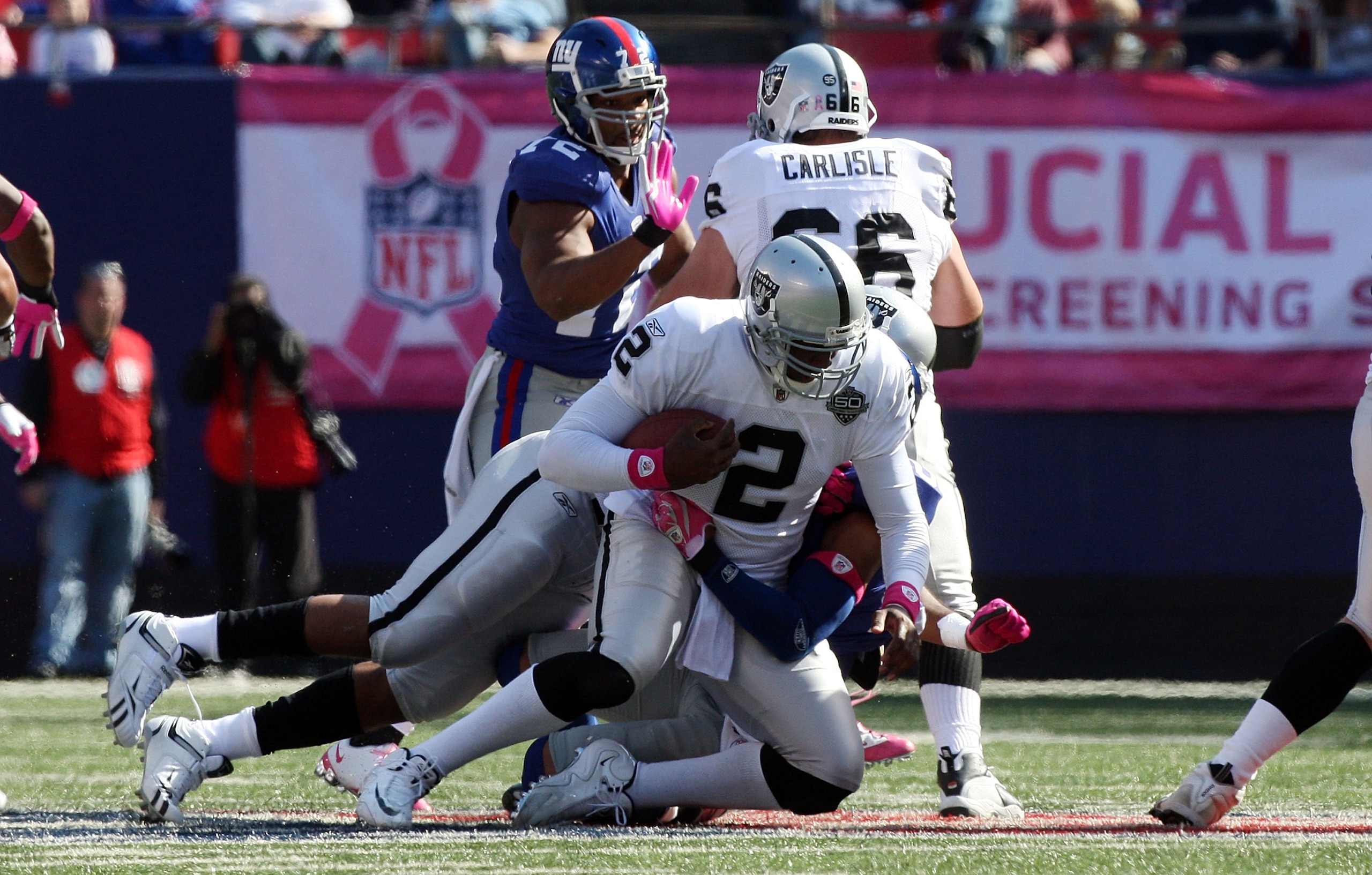 EAST RUTHERFORD, NJ - OCTOBER 11: JaMarcus Russell #2 of the Oakland Raiders is sacked by Michael Johnson #20 of the New York Giants on October 11, 2009 at Giants Stadium in East Rutherford, New Jersey. (Photo by Jim McIsaac/Getty Images) EAST RUTHERFORD, NJ - OCTOBER 11: JaMarcus Russell #2 of the Oakland Raiders is sacked by Michael Johnson #20 of the New York Giants on October 11, 2009 at Giants Stadium in East Rutherford, New Jersey. (Photo by Jim McIsaac/Getty Images)