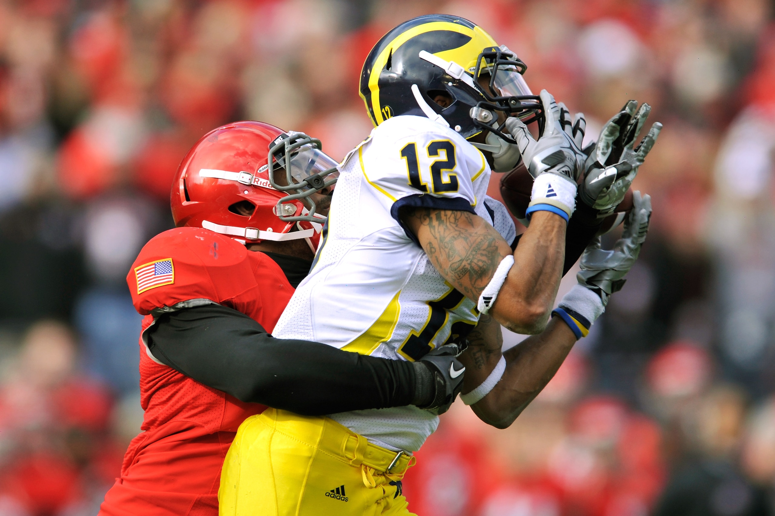 COLUMBUS, OH - NOVEMBER 27:  Jermale Hines #7 of the Ohio State Buckeyes gets his hand in to break up a pass attempt for Roy Roundtree #12 of the Michigan Wolverines at Ohio Stadium on November 27, 2010 in Columbus, Ohio.  (Photo by Jamie Sabau/Getty Imag