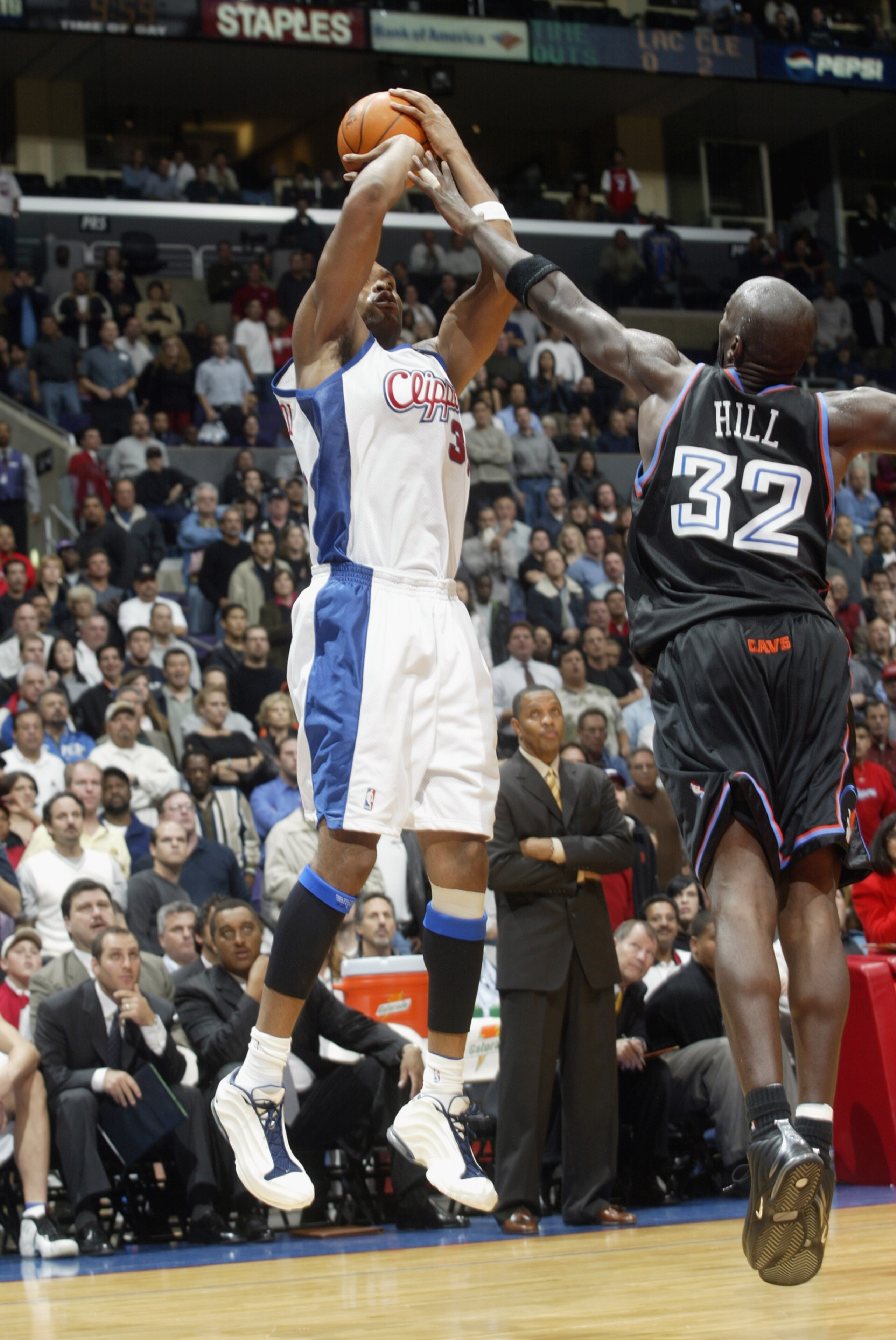 LOS ANGELES - OCTOBER 30:  Michael Olowokandi #34 of the Los Angeles Clippers puts a shot up over Tyrone Hill #32 of the Cleveland Cavaliers during the game at Staples Center on October 30, 2002 in Los Angeles, California.  The Cavaliers won 98-96.  NOTE