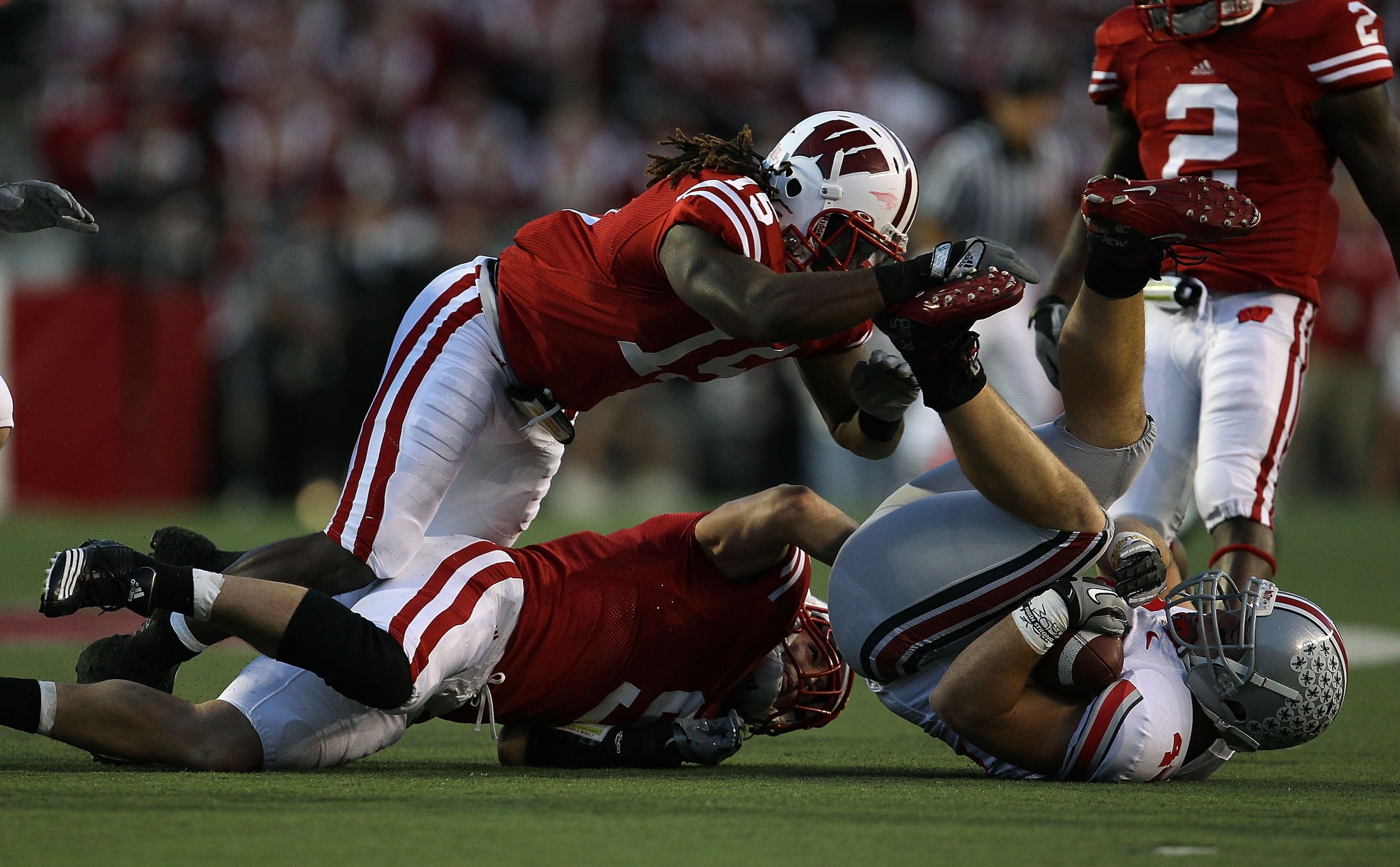MADISON, WI - OCTOBER 16: Blake Sorensen #9 and Culmer St. Jean #15 of the Wisconsin Badgers topple Zach Boren #44 of the Ohio State Buckeyes at Camp Randall Stadium on October 16, 2010 in Madison, Wisconsin. (Photo by Jonathan Daniel/Getty Images)
