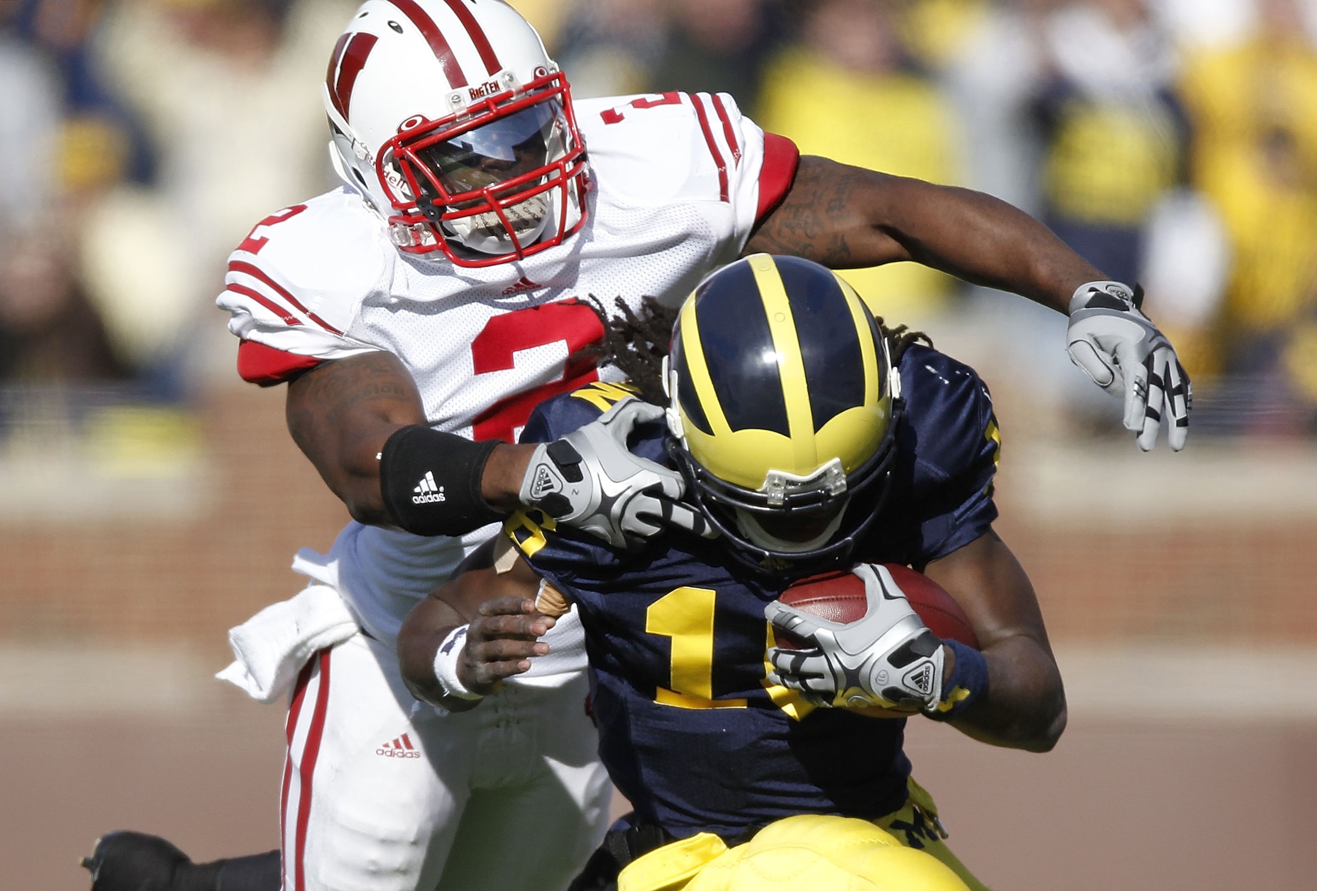 ANN ARBOR, MI - NOVEMBER 20:  Jay Valai #2 of the Wisconsin Badgers tackles Denard Robinson #16 of the Michigan Wolverines at Michigan Stadium on November 20, 2010 in Ann Arbor, Michigan.  (Photo by Gregory Shamus/Getty Images)