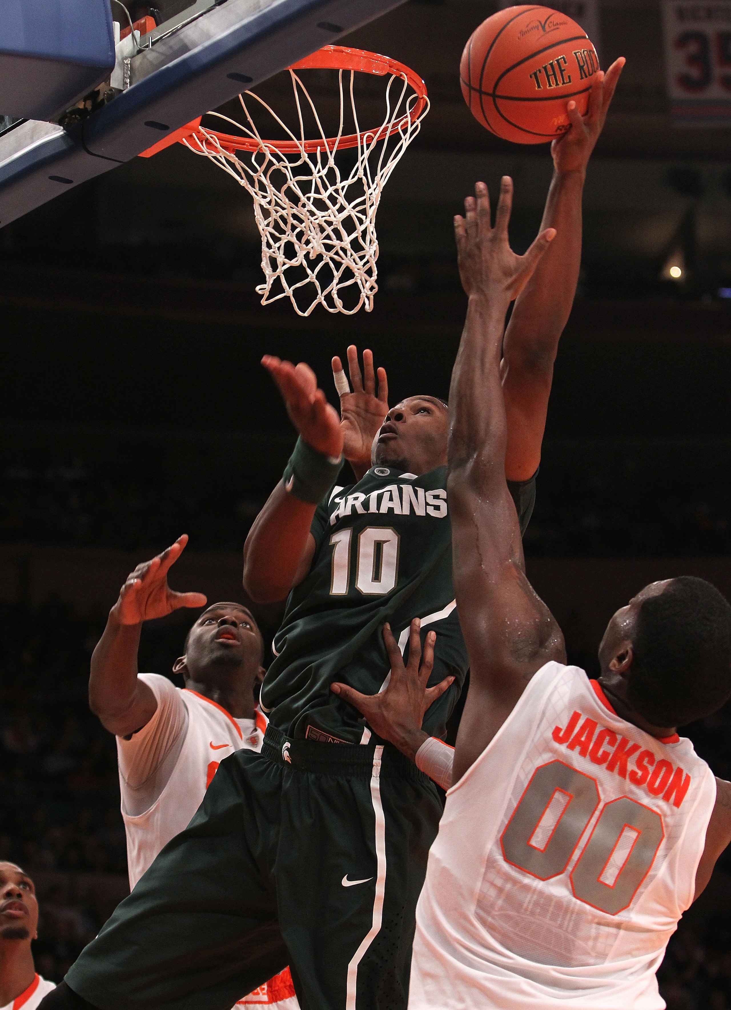 NEW YORK, NY - DECEMBER 07: Delvon Roe #10 of the Michigan Spartans shoots the ball under pressure from Rick Jackson #00 of Syracuse Orange during their game at the Jimmy V Classic at Madison Square Garden on December 7, 2010 in New York City.  (Photo by