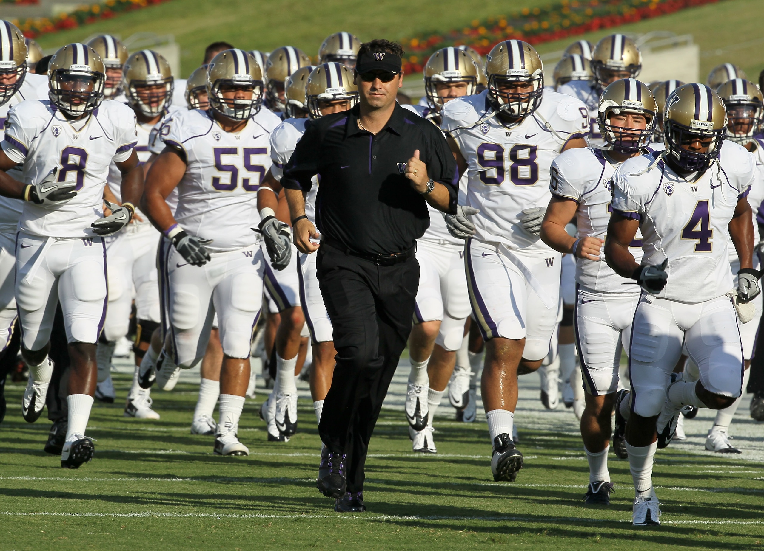 LOS ANGELES - OCTOBER 2: Head coach Steve Sarkisian of the Washington Huskies runs off the field with his team after warmups for th game with the USC Trojans at the Los Angeles Memorial Coliseum on October 2, 2010 in Los Angeles, California. (Photo b LOS ANGELES - OCTOBER 2: Head coach Steve Sarkisian of the Washington Huskies runs off the field with his team after warmups for th game with the USC Trojans at the Los Angeles Memorial Coliseum on October 2, 2010 in Los Angeles, California. (Photo b