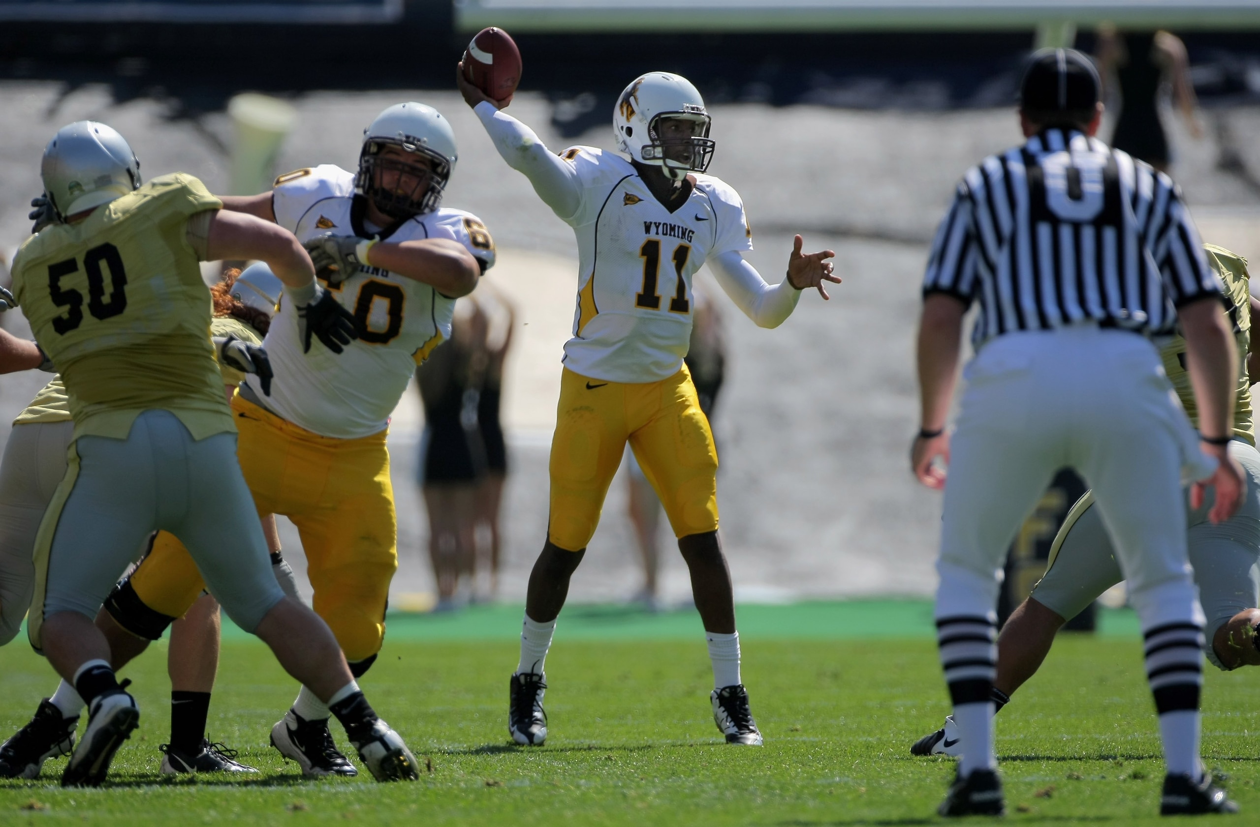 BOULDER, CO - SEPTEMBER 19: Quarterback Robert Benjamin #11 of the Wyoming Cowboys delivers a pass against the Colorado Buffaloes at Folsom Field on September 19, 2009 in Boulder, Colorado. The Buffaloes defeated the Cowboys 24-0. (Photo by Doug Pensing BOULDER, CO - SEPTEMBER 19: Quarterback Robert Benjamin #11 of the Wyoming Cowboys delivers a pass against the Colorado Buffaloes at Folsom Field on September 19, 2009 in Boulder, Colorado. The Buffaloes defeated the Cowboys 24-0. (Photo by Doug Pensing