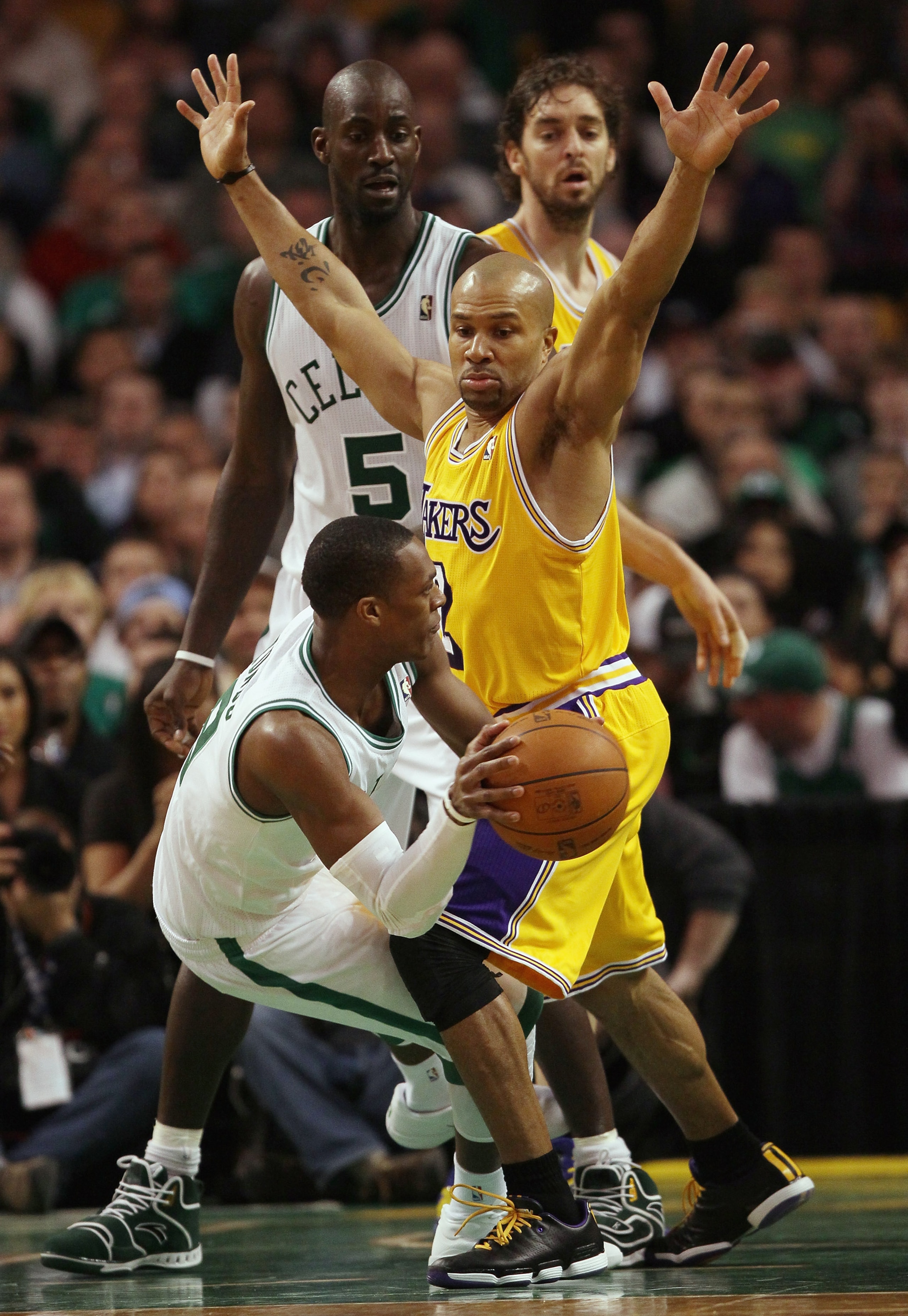 BOSTON, MA - FEBRUARY 10:  Rajon Rondo #9 of the Boston Celtics passes the ball as Derek Fisher #2 of the Los Angeles Lakers defends on February 10, 2011 at the TD Garden in Boston, Massachusetts.  The Lakers defeated the Celtics 92-86. NOTE TO USER: User