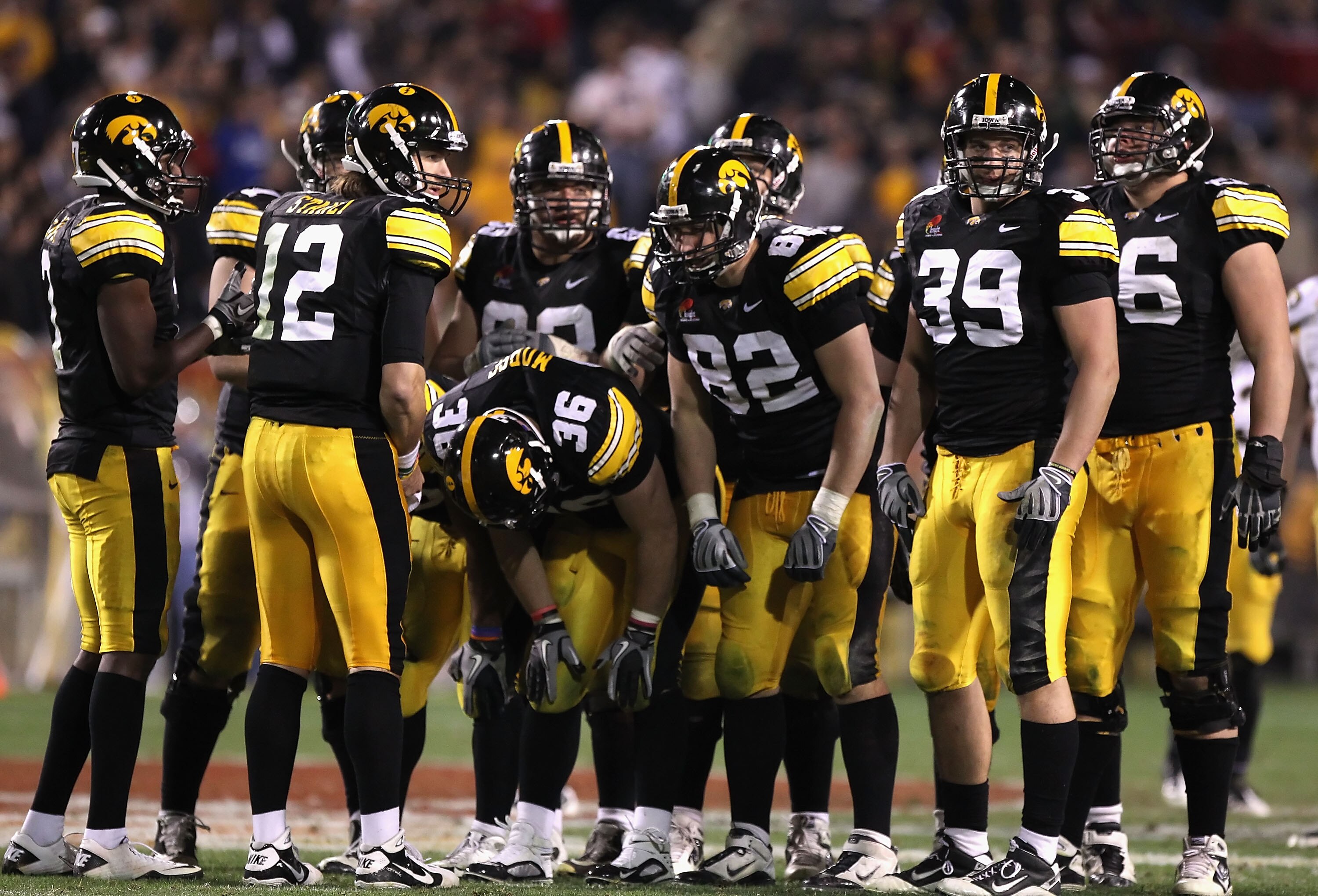 TEMPE, AZ - DECEMBER 28:  Quarterback Ricky Stanzi #12 of the Iowa Hawkeyes huddles up with teammates during the Insight Bowl against the Missouri Tigers at Sun Devil Stadium on December 28, 2010 in Tempe, Arizona.  The Hawkeyes defeated the Tigers 27-24.