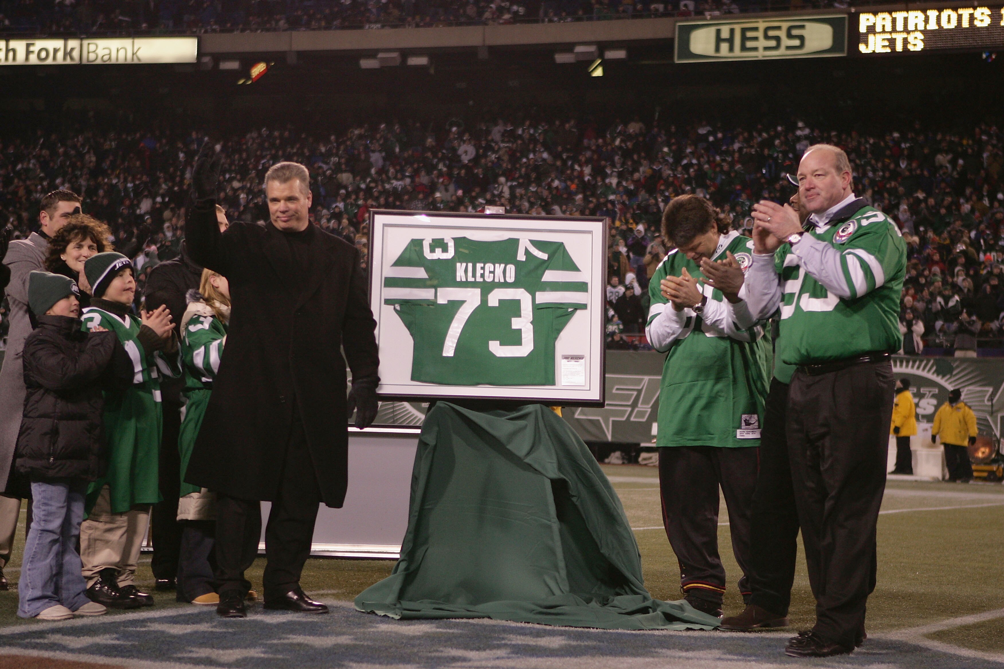 EAST RUTHERFORD, NJ - DECEMBER 26:  Former player Joe Klecko (L) of the New York Jets gets his jersey retired during halftime against the New England Patriots on December 26, 2004 at Giants Stadium in East Rutherford, New Jersey. The Patriots defeated the