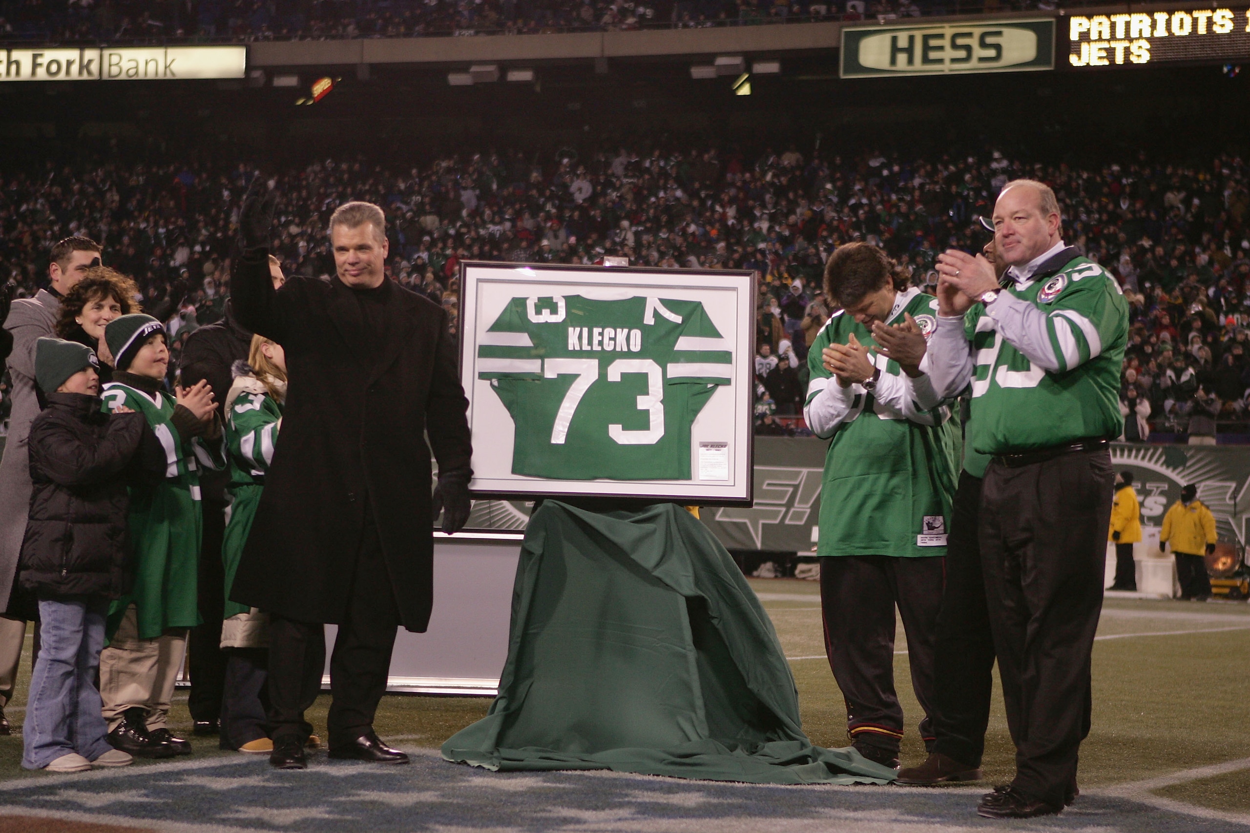 EAST RUTHERFORD, NJ - DECEMBER 26:  Former player Joe Klecko (L) of the New York Jets gets his jersey retired during halftime against the New England Patriots on December 26, 2004 at Giants Stadium in East Rutherford, New Jersey. The Patriots defeated the