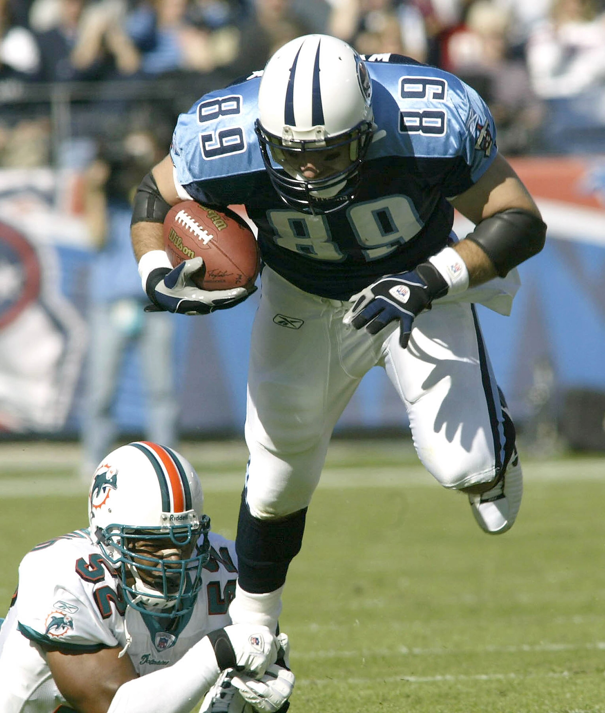 NASHVILLE, TN - NOVEMBER 9:  Frank Wychek #89 of the Tennessee Titans breaks away from Morlon Greenwood #52 of the Miami Dolphins  during the first half of a NFL game on November 9, 2003 at The Coliseum in Nashville, Tennessee.  (Photo By Grant Halverson/