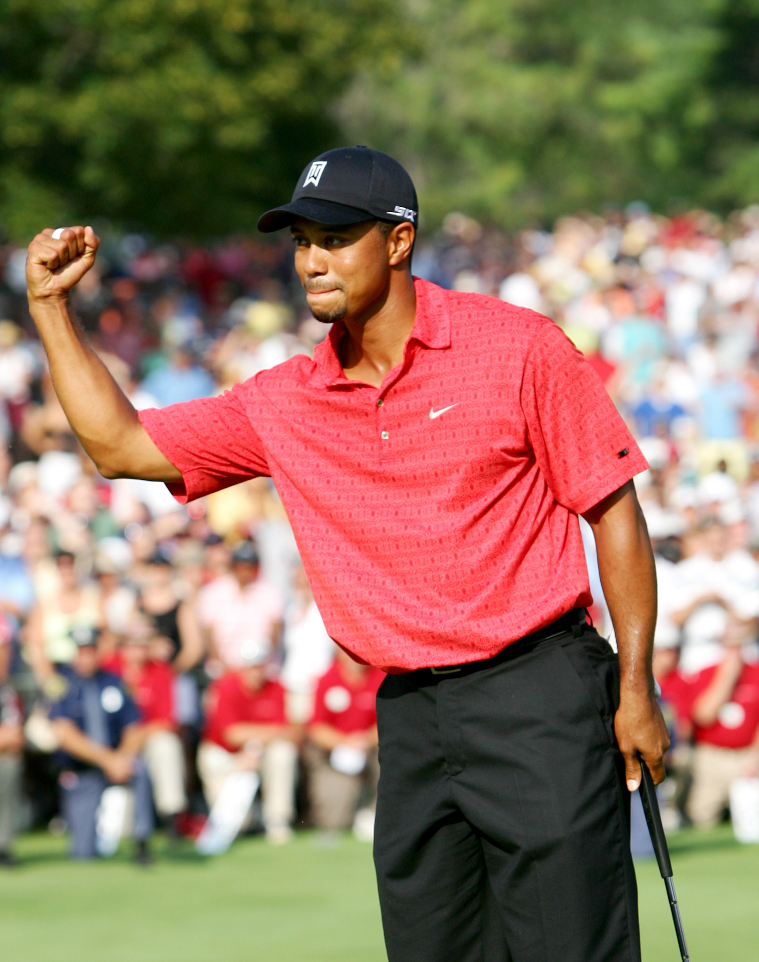 UNITED STATES - AUGUST 06:  Tiger Woods celebrates his win at the Buick Open at Warwick Hills Golf and Country Club in Grand Blanc, Michigan on August 6, 2006.  (Photo by Sam Greenwood/Getty Images)