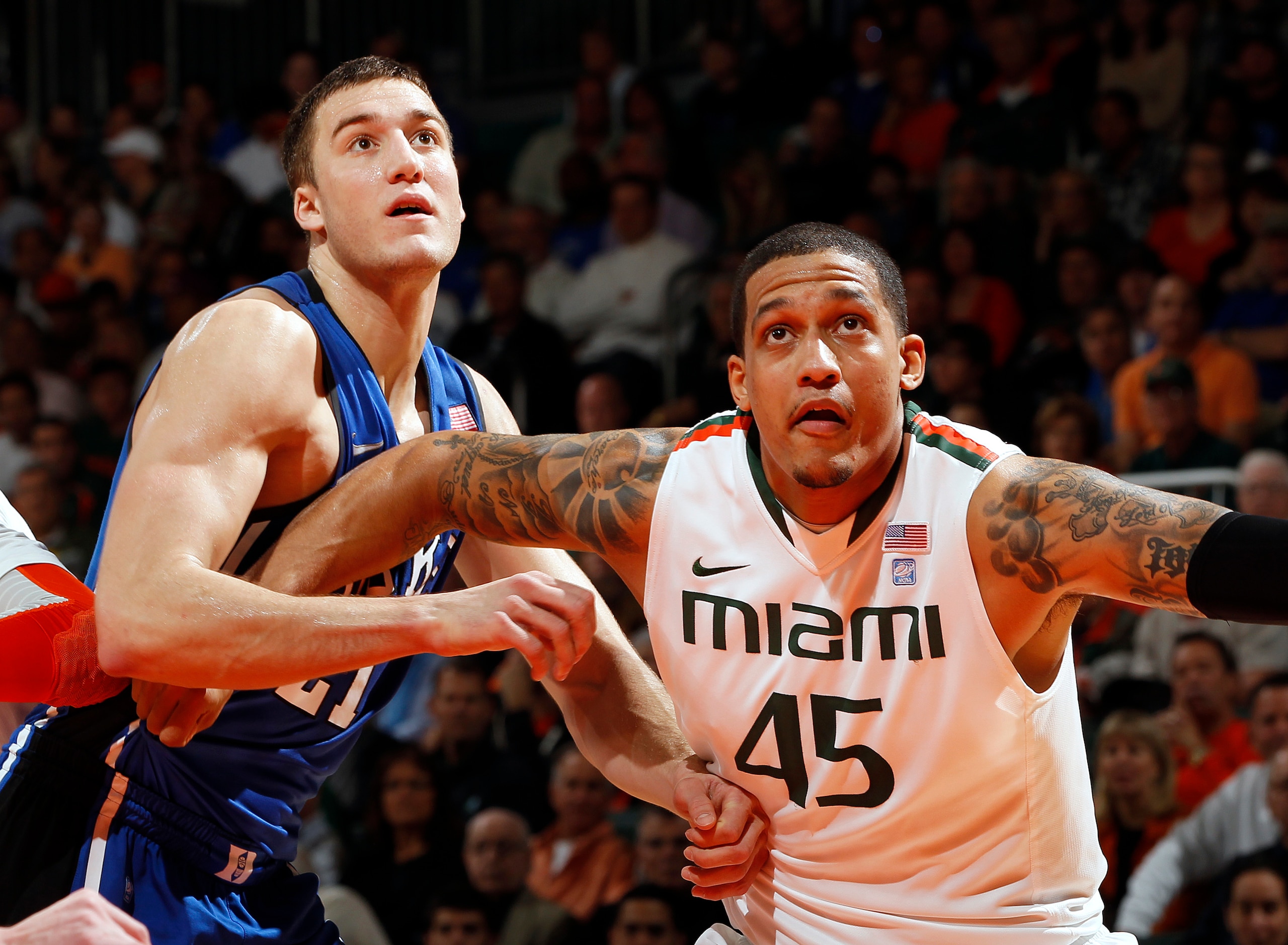 CORAL GABLES, FL - FEBRUARY 13: Julian Gamble #45 of the Miami Hurricanes fights for position with Miles Plumlee #21 of the Duke Blue Devils during a free throw on February 13, 2011 at the BankUnited Center in Coral Gables, Florida. The Blue Devils defeat