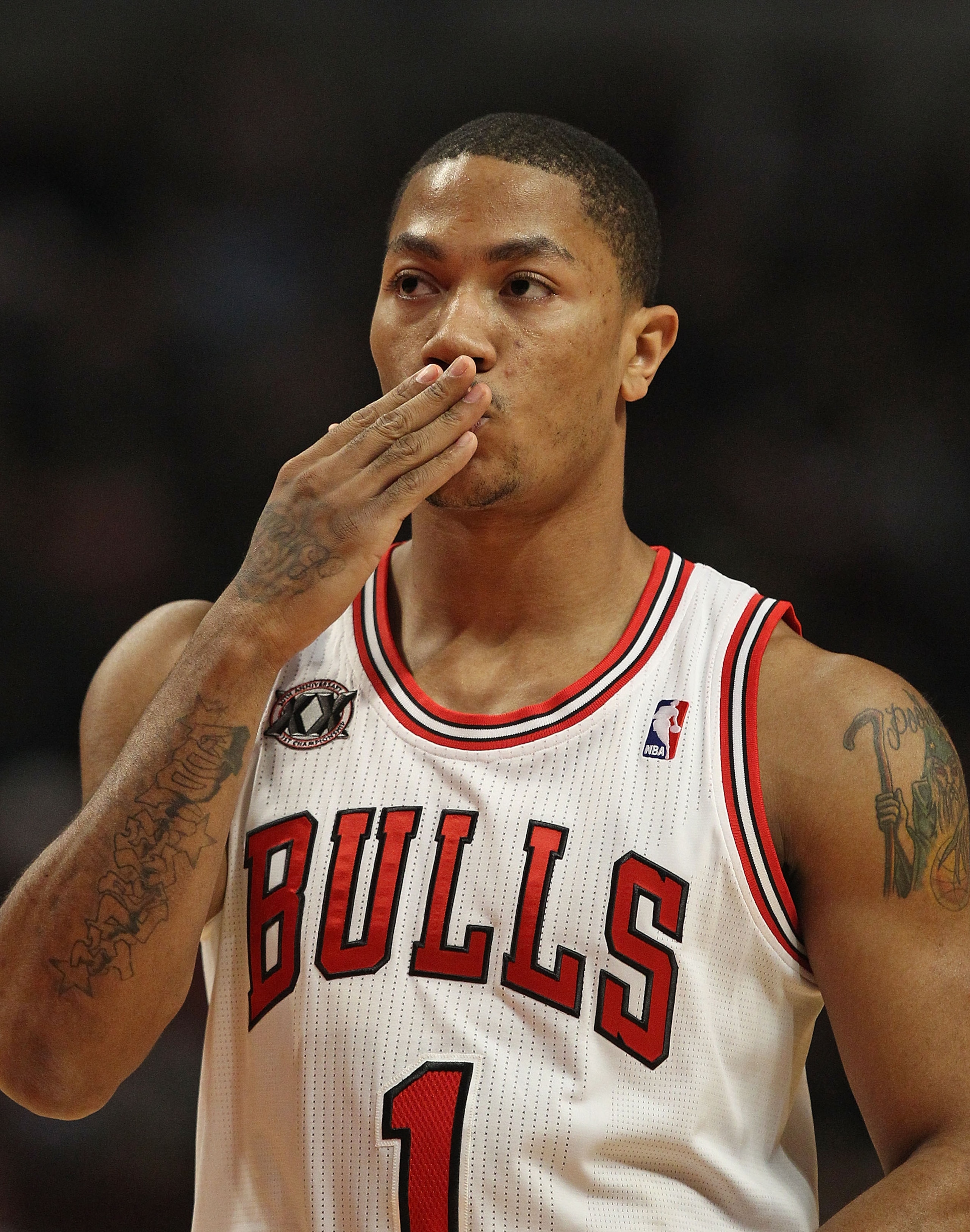 CHICAGO, IL - MARCH 07: Derrick Rose #1 of the Chicago Bulls blows a kiss to members of his family in the stands before the tip-off of a game against the New Orleans Hornets at the United Center on March 7, 2011 in Chicago, Illinois. The Bulls defeated th