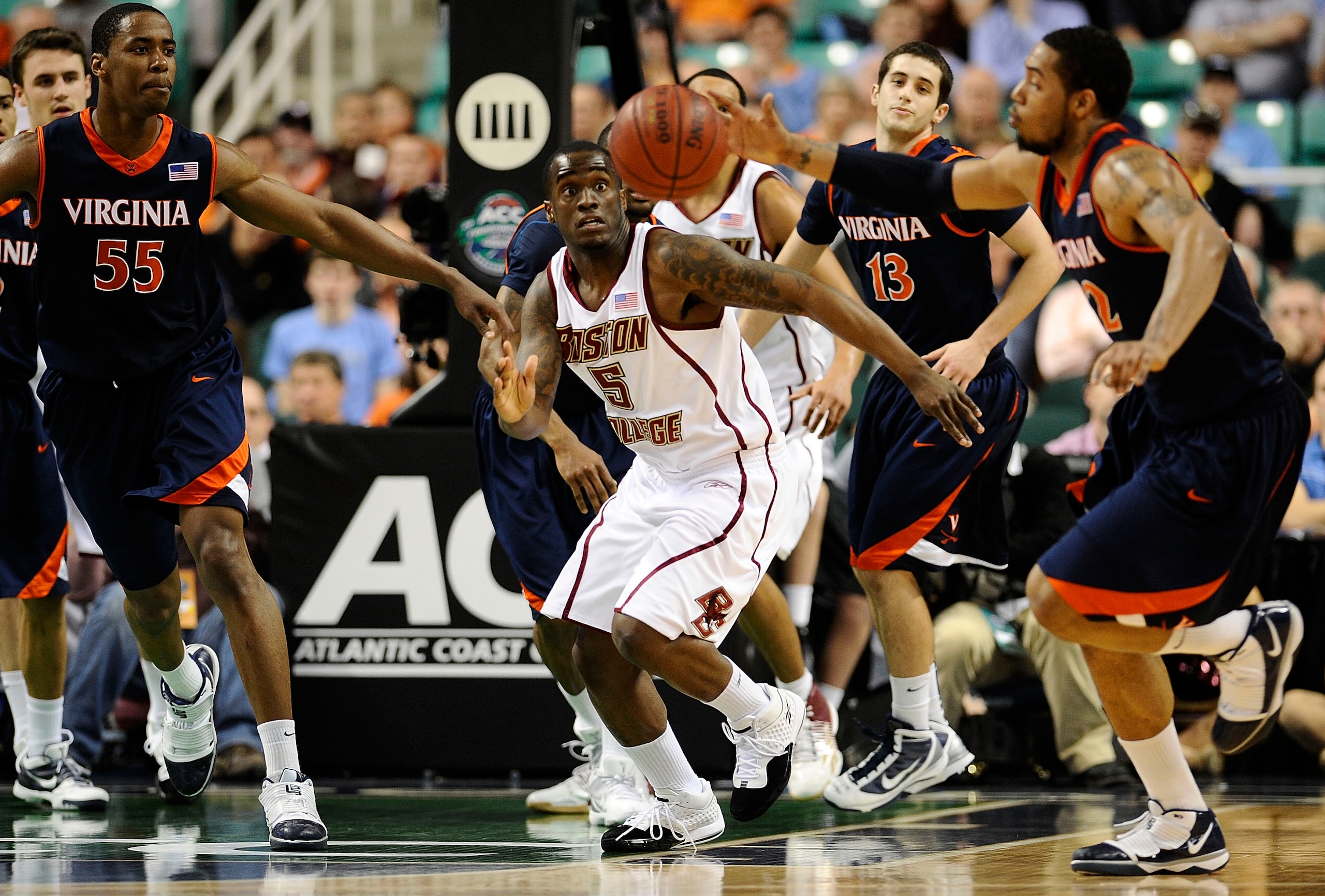 GREENSBORO, NC - MARCH 11:  Biko Paris #5 of the Boston College Eagles eyes a loose ball gathered in by MIke Scott #32 of the University of Virginia Cavaliers in their first round game in the 2010 ACC Men's Basketball Tournament at the Greensboro Coliseum