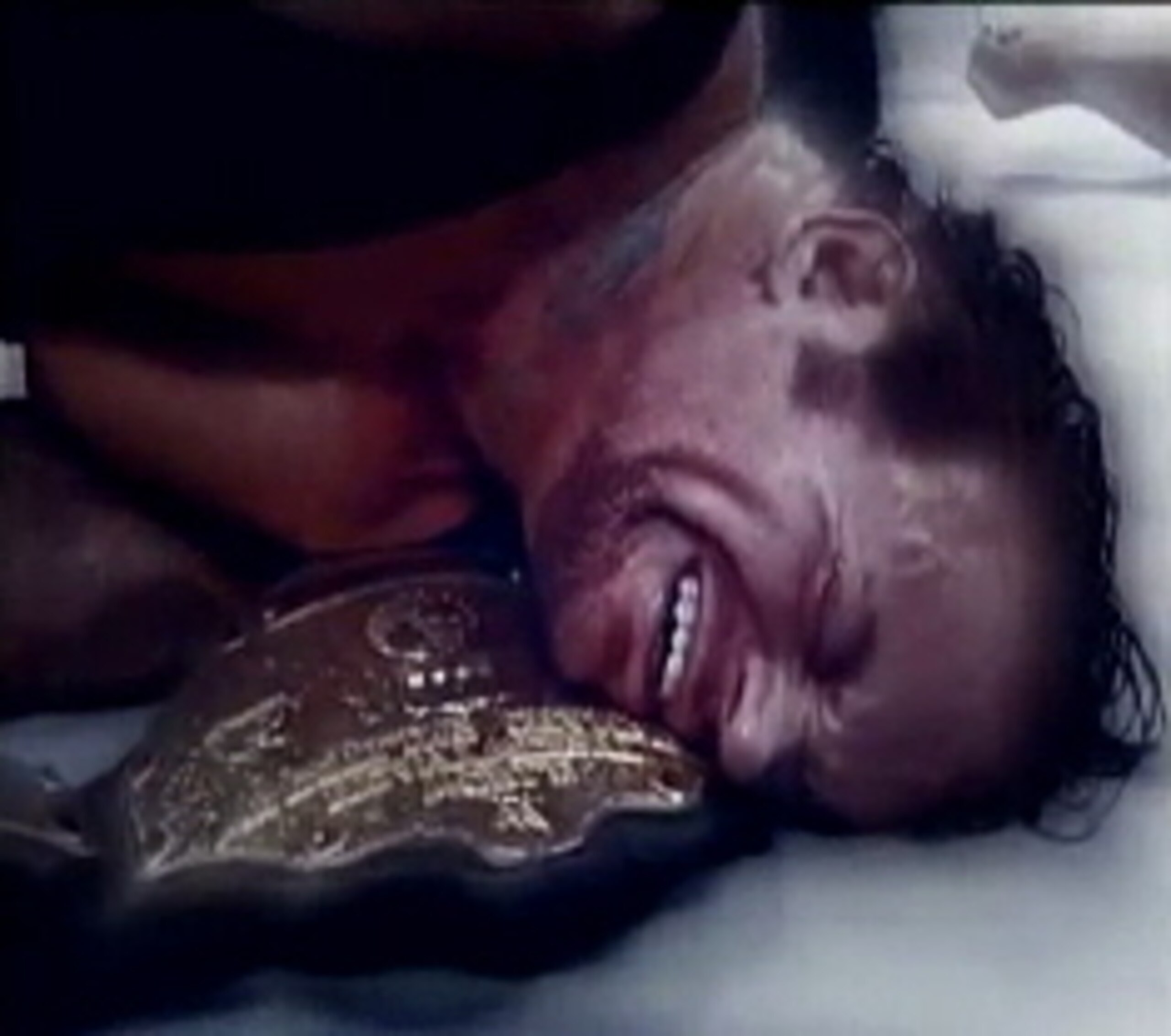 Undertaker with his title after an attack from Edge