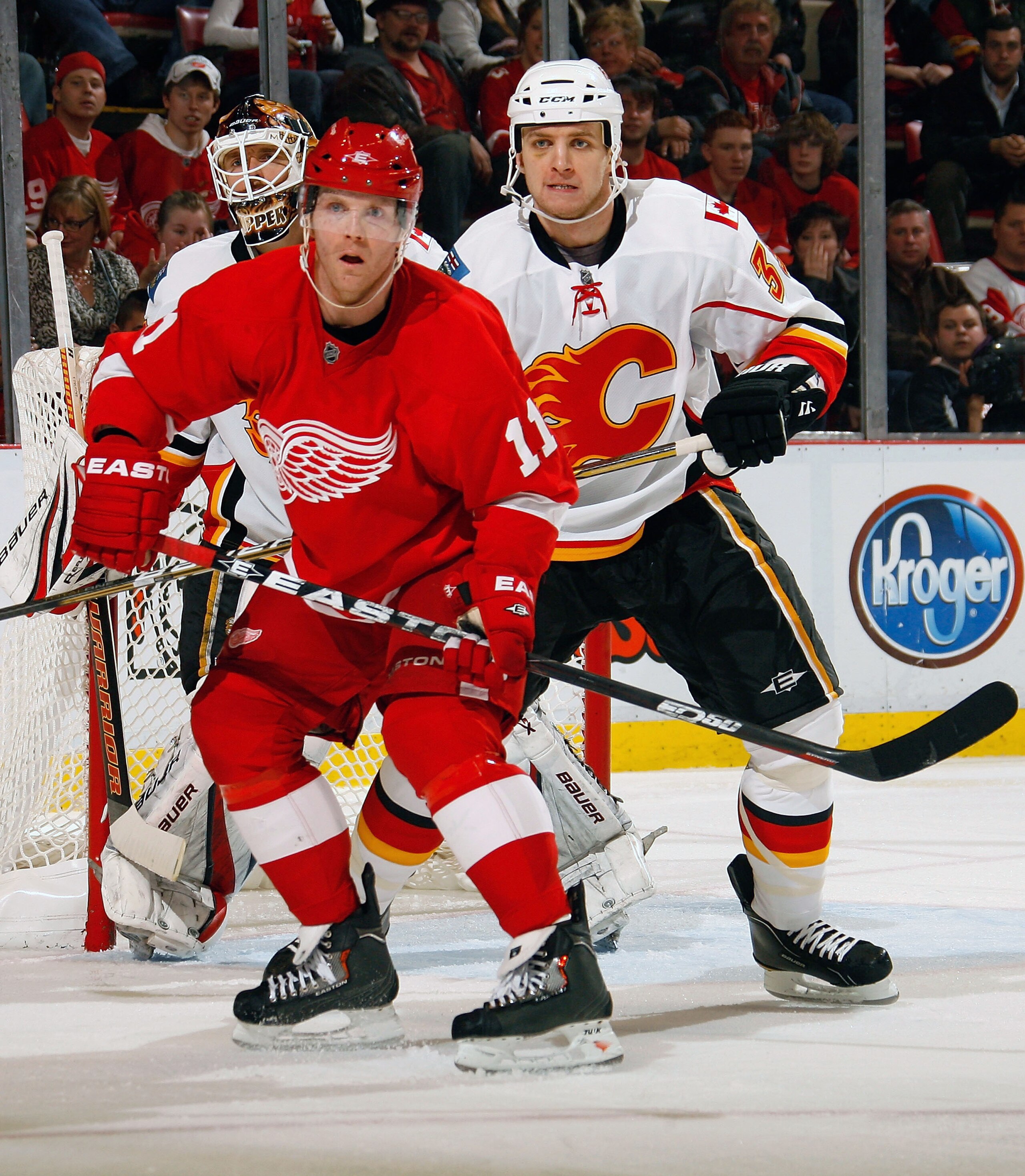 DETROIT, MI - NOVEMBER 21:  Anton Babchuk #33 of the Calgary Flames battles for position with Dan Cleary #11 of the Detroit Red Wings during their NHL game at Joe Louis Arena on November 21, 2010 in Detroit, Michigan.(Photo by Dave Sandford/Getty Images)