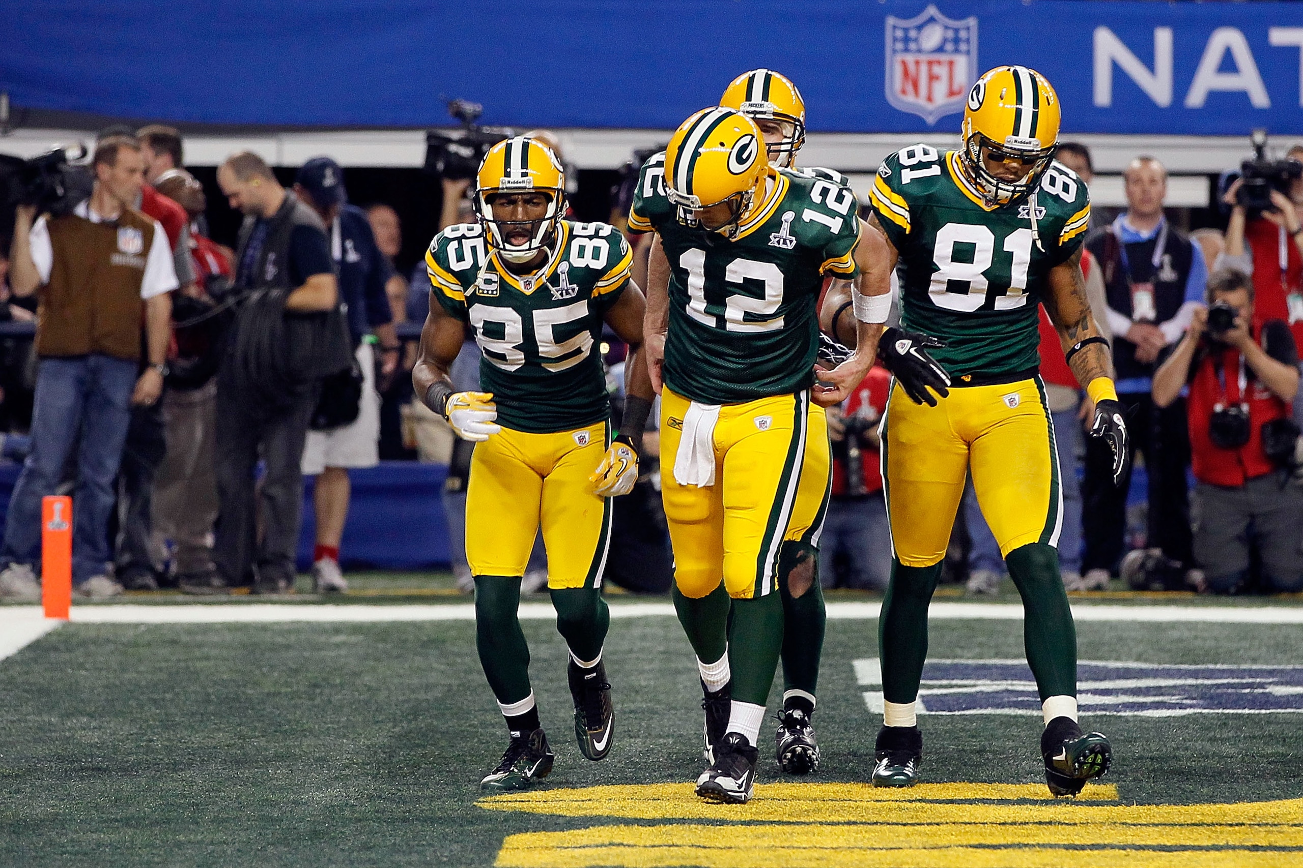 ARLINGTON, TX - FEBRUARY 06:  Aaron Rodgers #12 of the Green Bay Packers gestures putting on a championship belt as he celebrates a Green Bay touchdown against the Pittsburgh Steelers during Super Bowl XLV at Cowboys Stadium on February 6, 2011 in Arlingt