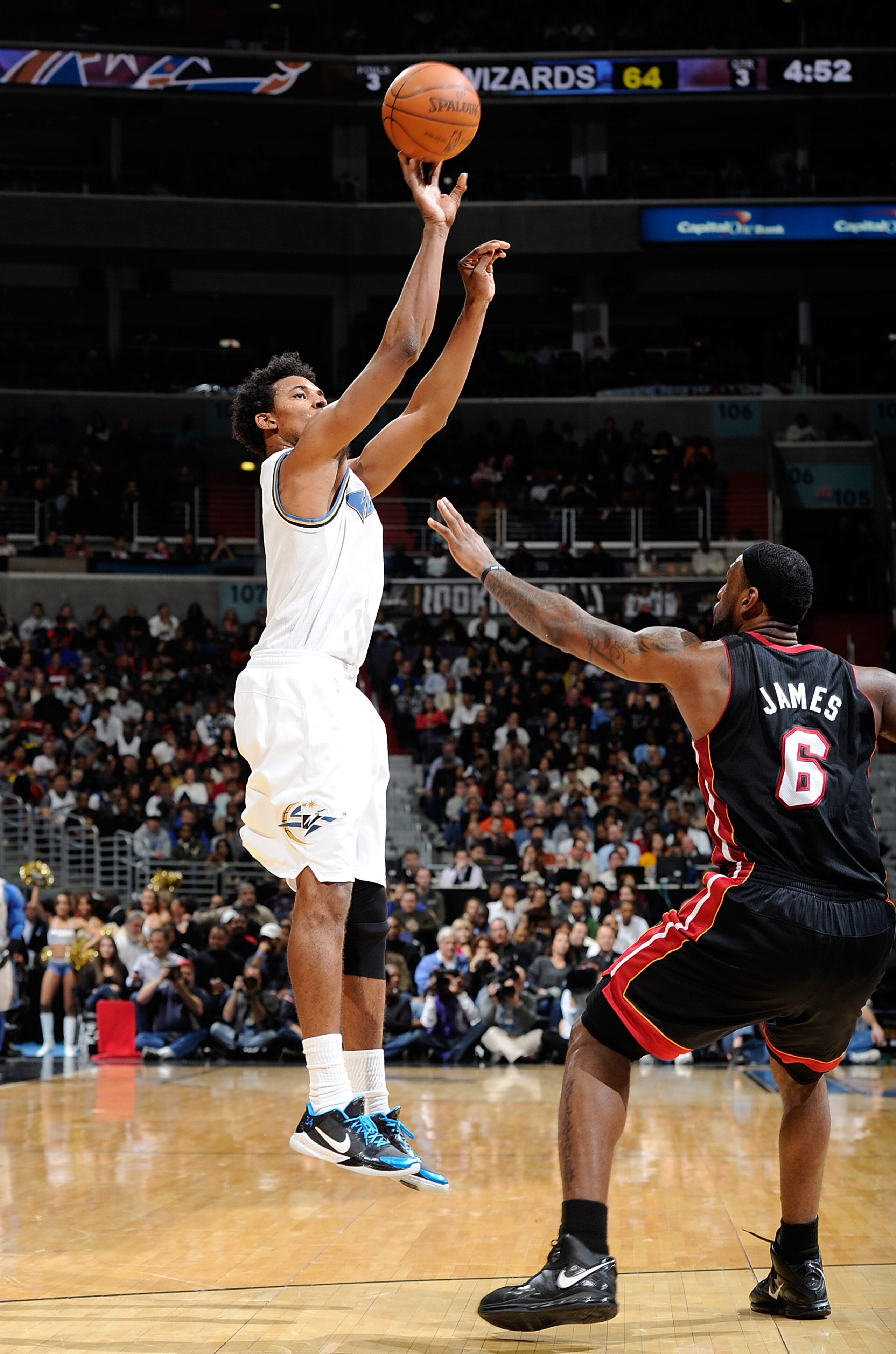 WASHINGTON - DECEMBER 18:  Nick Young #1 of the Washington Wizards shoots over Lebron James #6 of the Miami Heat at the Verizon Center on December 18, 2010 in Washington, DC.NOTE TO USER: User expressly acknowledges and agrees that, by downloading and or