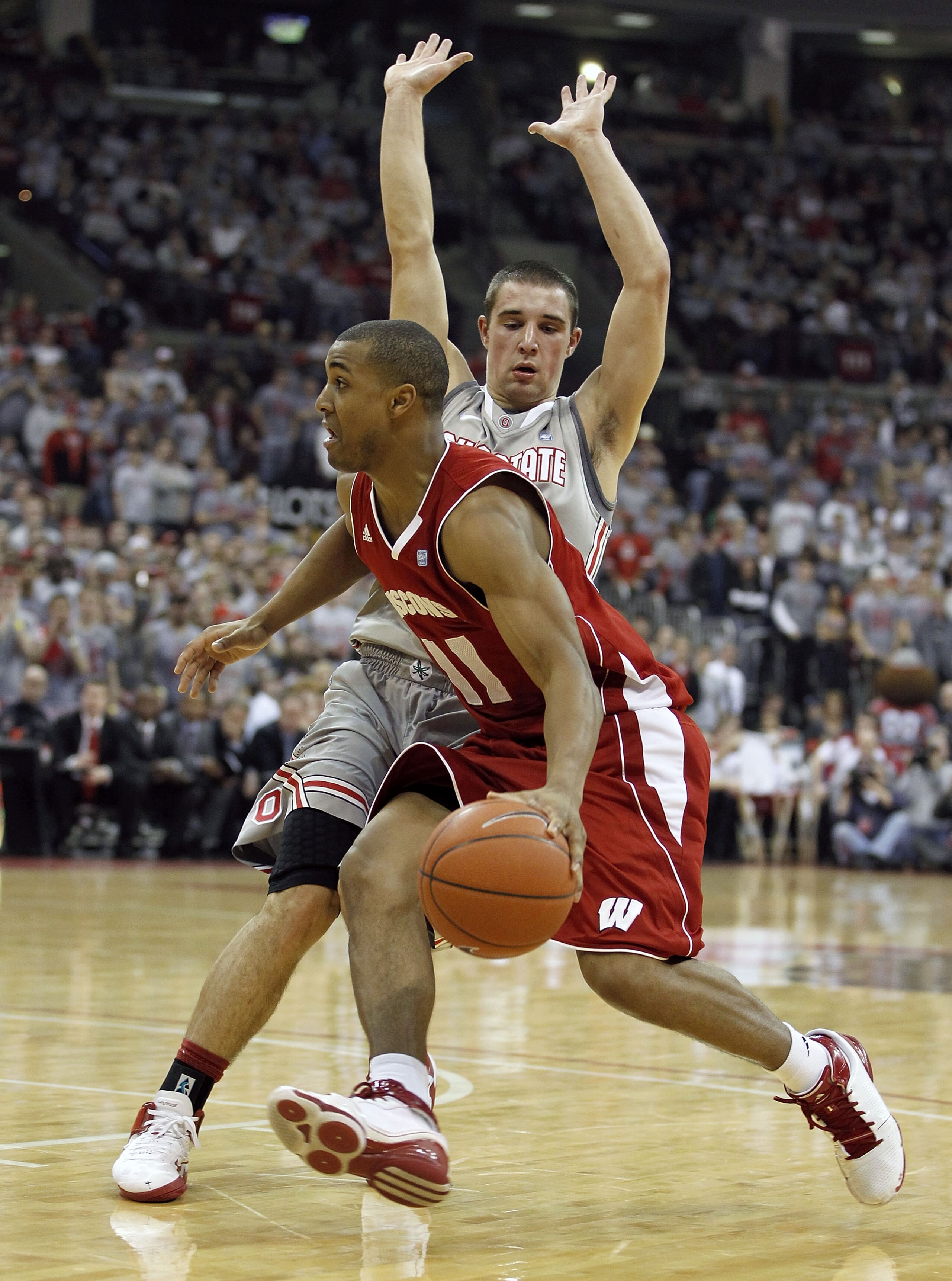 COLUMBUS, OH - MARCH 06:  Jordan Taylor #11 of the Wisconsin Badgers drives around Aaron Craft #4 of the Ohio State Buckeyes on March 6, 2011 at the Value City Arena in Columbus, Ohio. Ohio State won the game 93-65.  (Photo by Gregory Shamus/Getty Images)