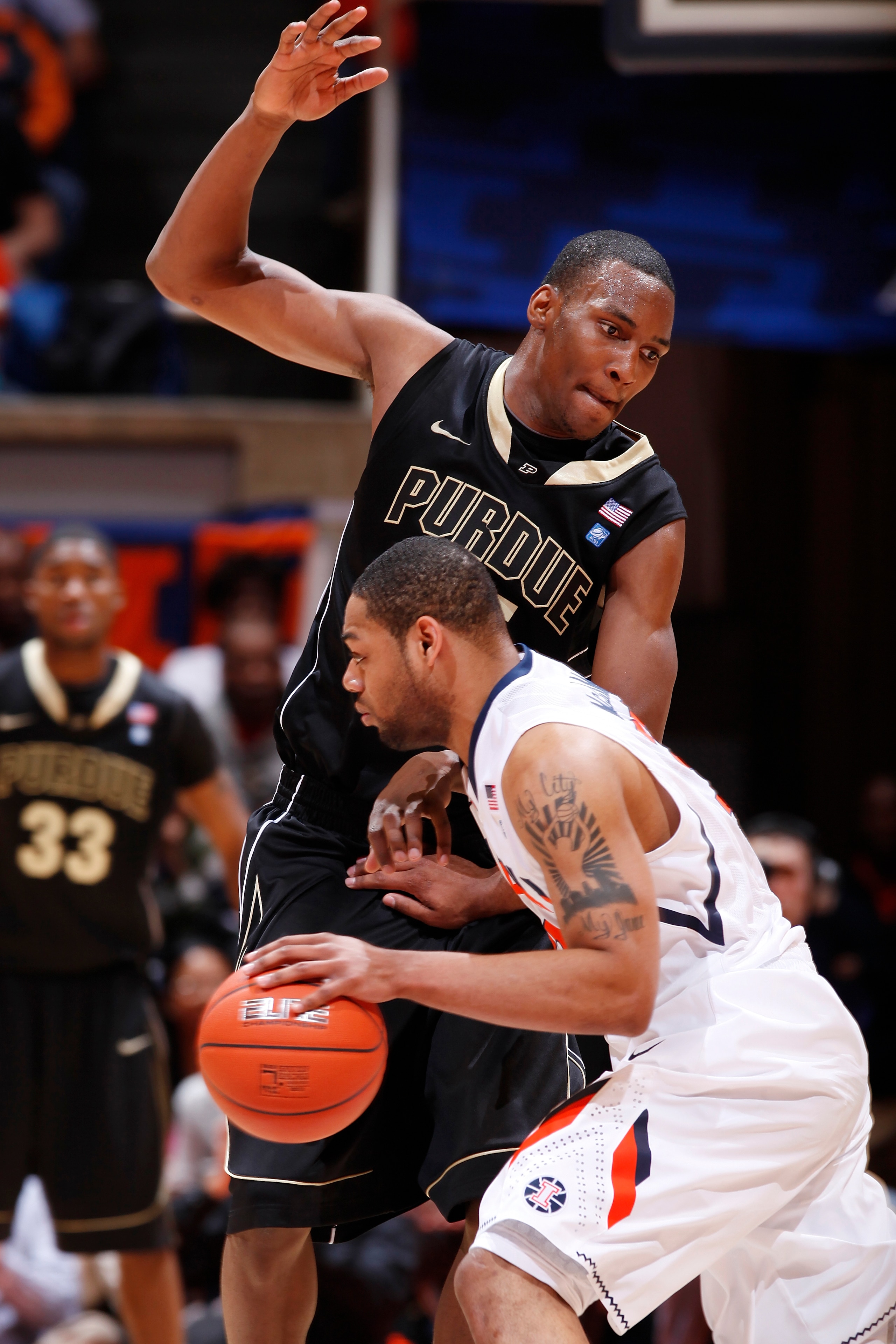 CHAMPAIGN, IL - FEBRUARY 13: JaJuan Johnson #25 of the Purdue Boilermakers defends against Demetri McCamey #32 of the Illinois Fighting Illini at Assembly Hall on February 13, 2011 in Champaign, Illinois. Purdue defeated Illinois 81-70. (Photo by Joe Robb