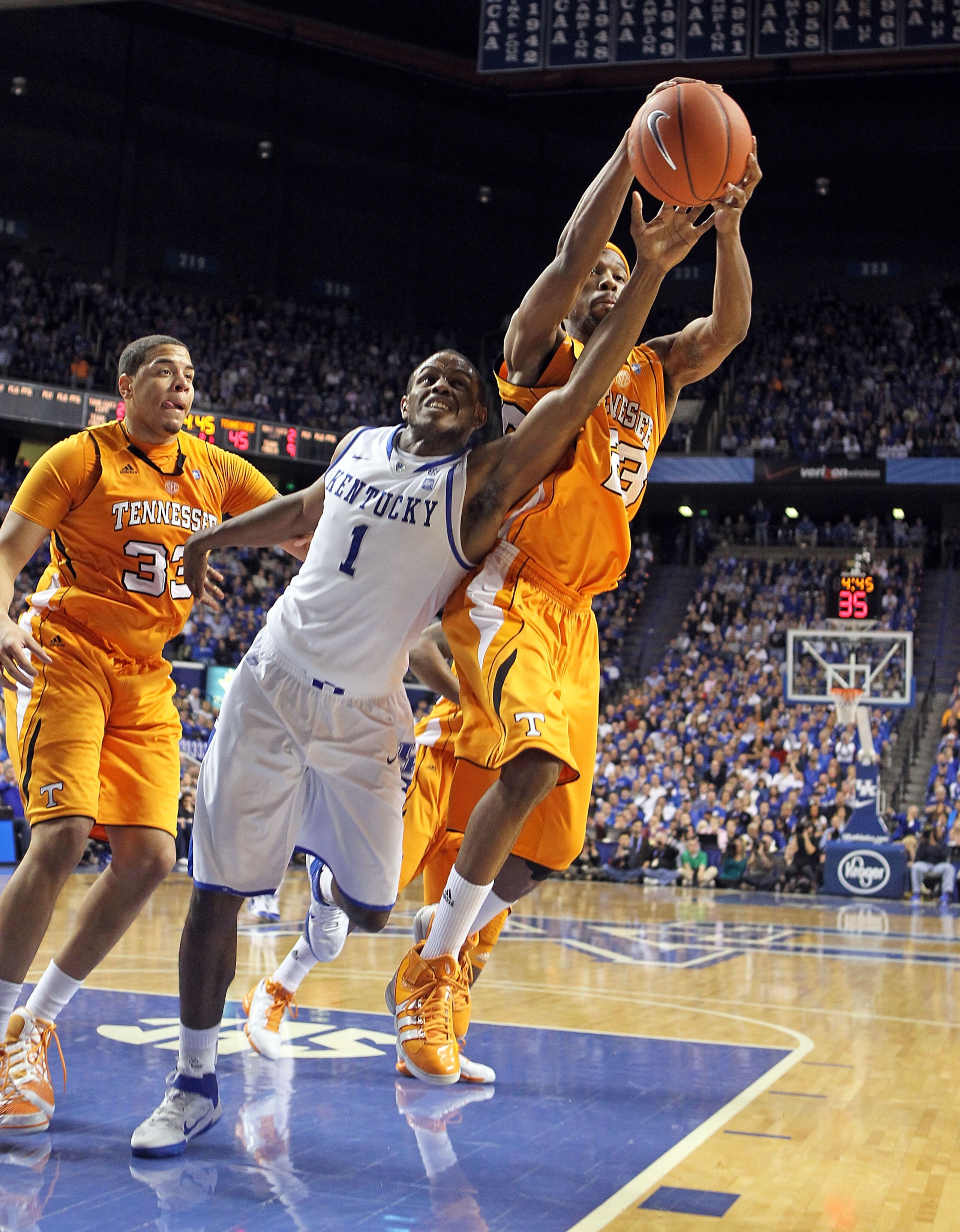 LEXINGTON, KY - FEBRUARY 08:  Darius Miller #1 of the Kentucky Wildcats and Cameron Tatum #23 of the Tennessee Volunteers reach for a rebound during the SEC game at Rupp Arena on February 8, 2011 in Lexington, Kentucky. Kentucky won 73-61.  (Photo by Andy