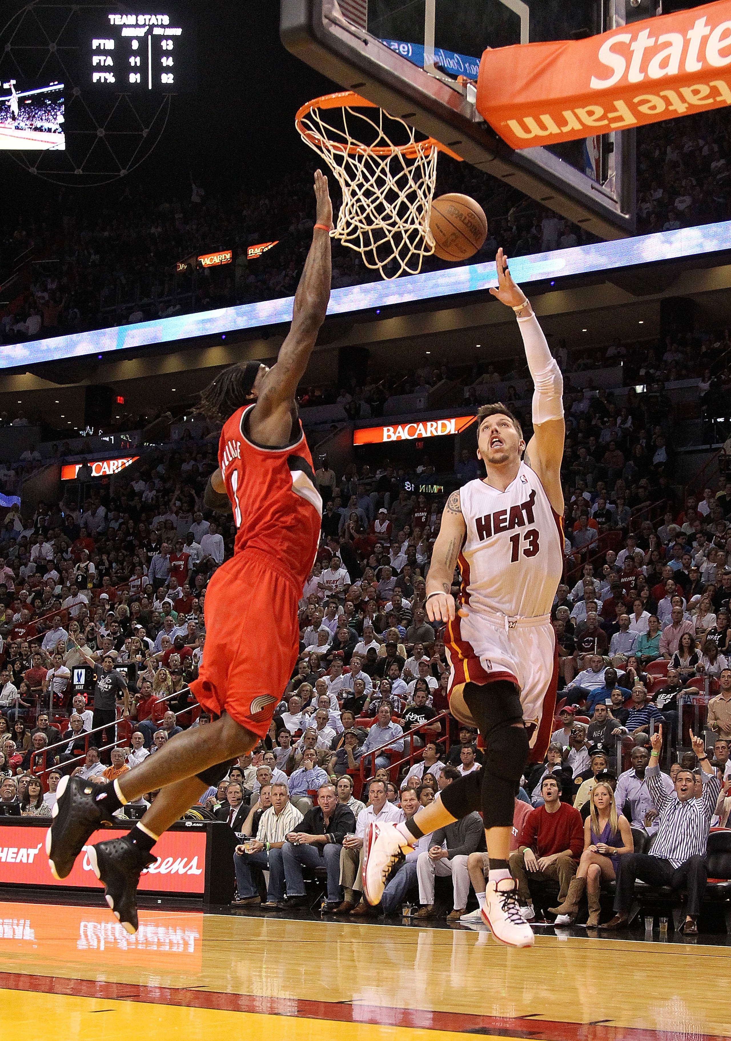 MIAMI, FL - MARCH 08:  Mike Miller #13 of the Miami Heat drives on  Gerald Wallace #3 of the Portland Trail Blazers during a game at American Airlines Arena on March 8, 2011 in Miami, Florida. NOTE TO USER: User expressly acknowledges and agrees that, by