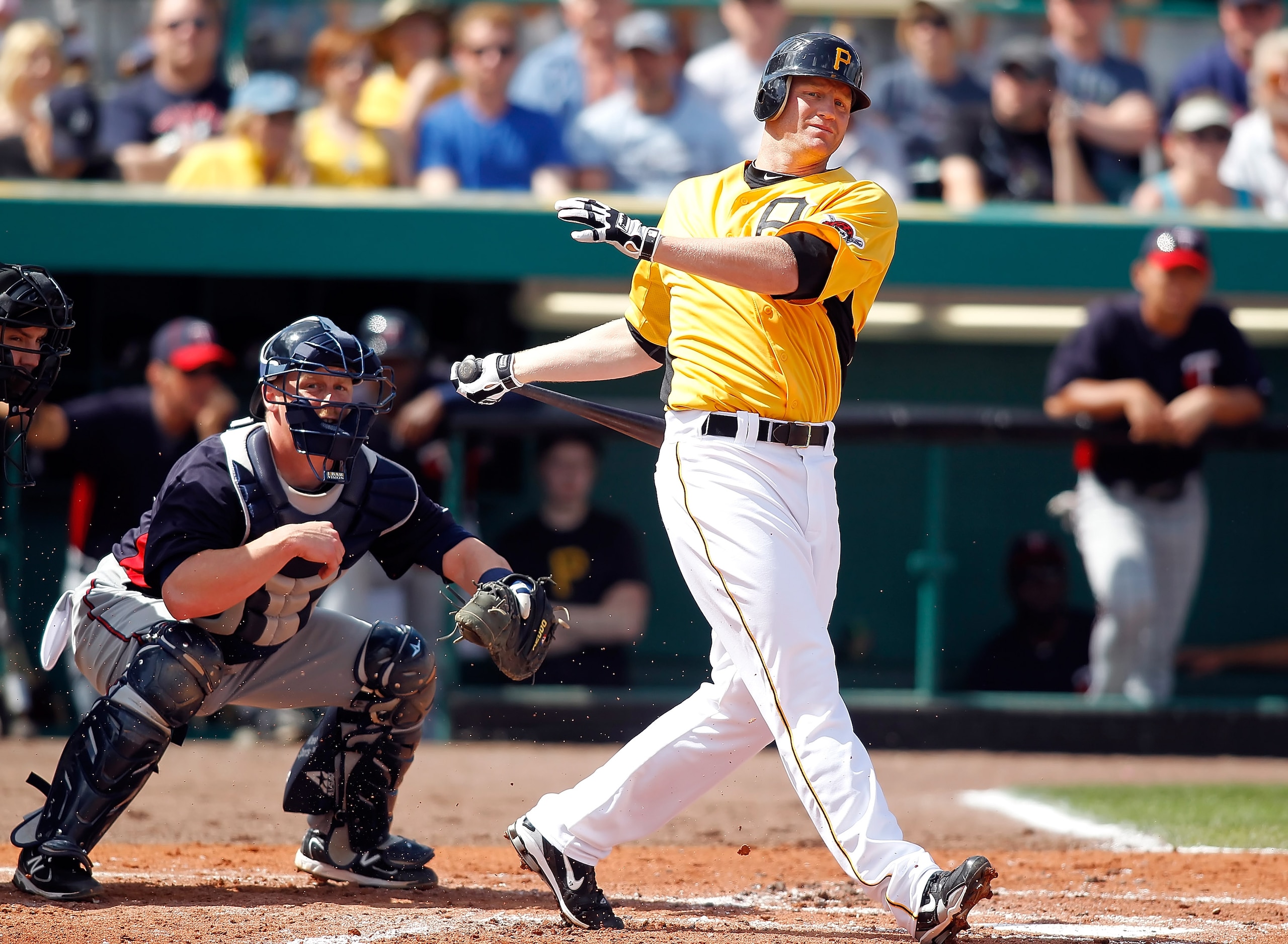 BRADENTON, FL - MARCH 02:  Infielder Lyle Overbay #37 of the Pittsburgh Pirates fouls off a pitch as catcher Steve Holm #27 of the Minnesota Twins looks on during a Grapefruit League Spring Training Game at McKechnie Field on March 2, 2011 in Bradenton, F