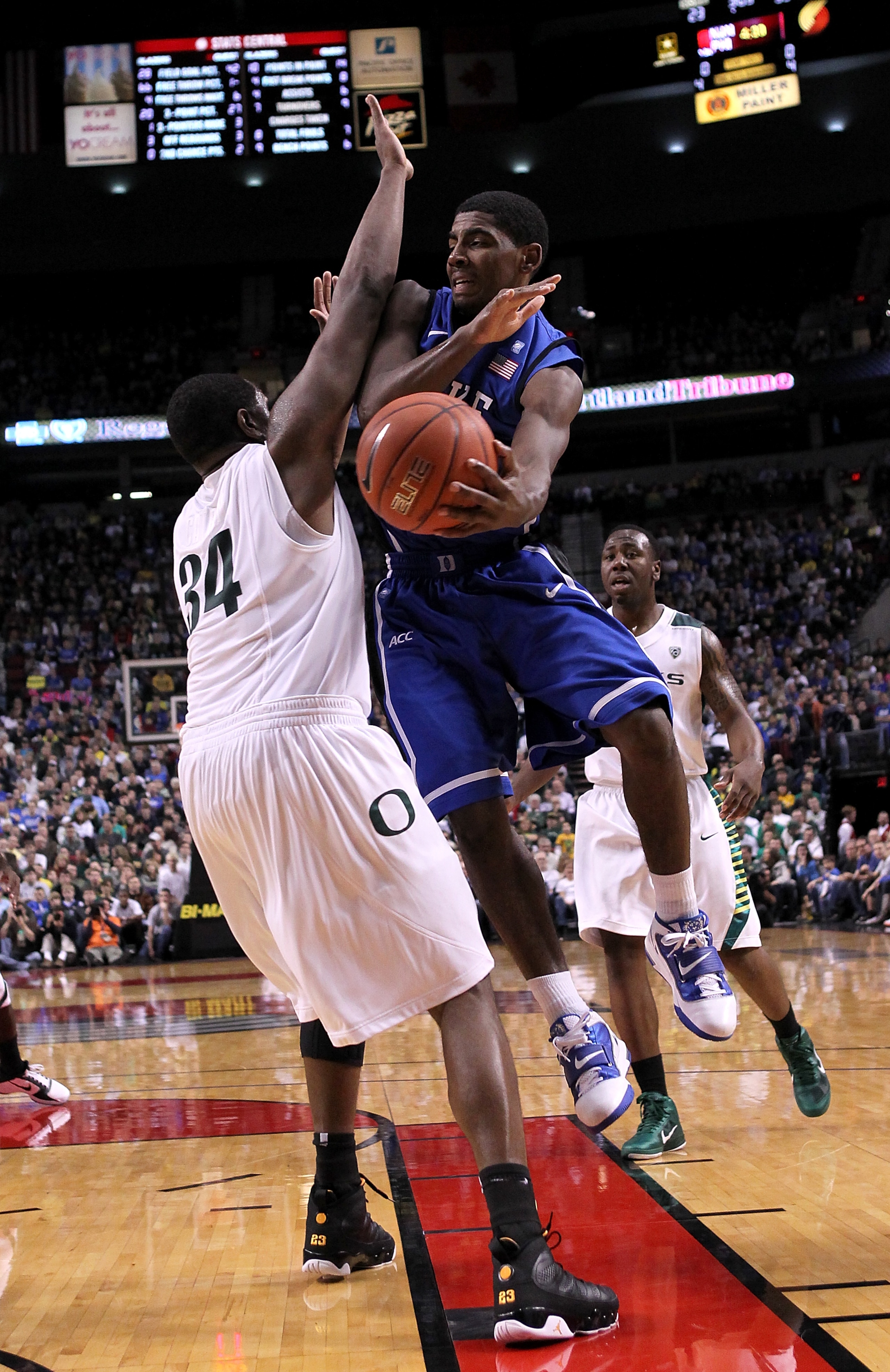 PORTLAND, OR - NOVEMBER 27:  Kyrie Irving #1 of the Duke Blue Devils looks to pass the ball against Joevan Catron #34 of the Oregon Ducks on November 27, 2010 at the Rose Garden in Portland, Oregon.  (Photo by Jonathan Ferrey/Getty Images)