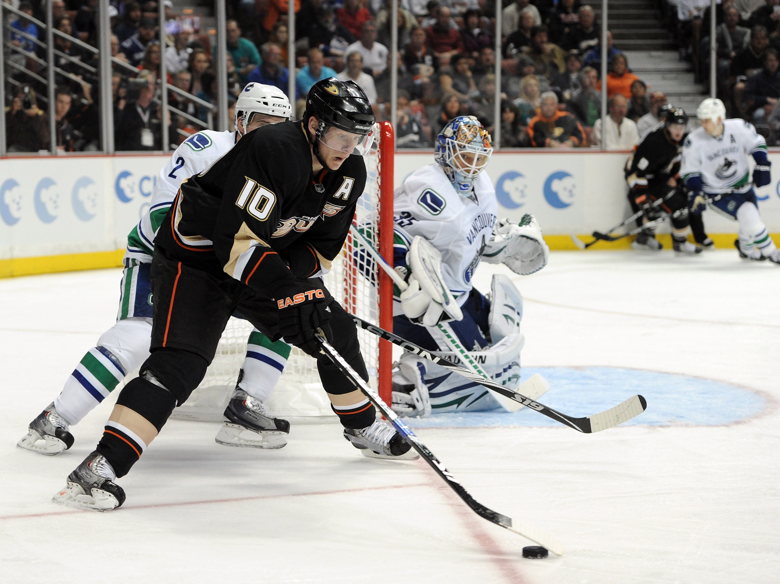 ANAHEIM, CA - MARCH 06:  Cory Schneider #35 of the Vancouver Canucks watches Corey Perry #10 of the Anaheim Ducks as he skates from behind the net at the Honda Center on March 6, 2011 in Anaheim, California.  (Photo by Harry How/Getty Images)