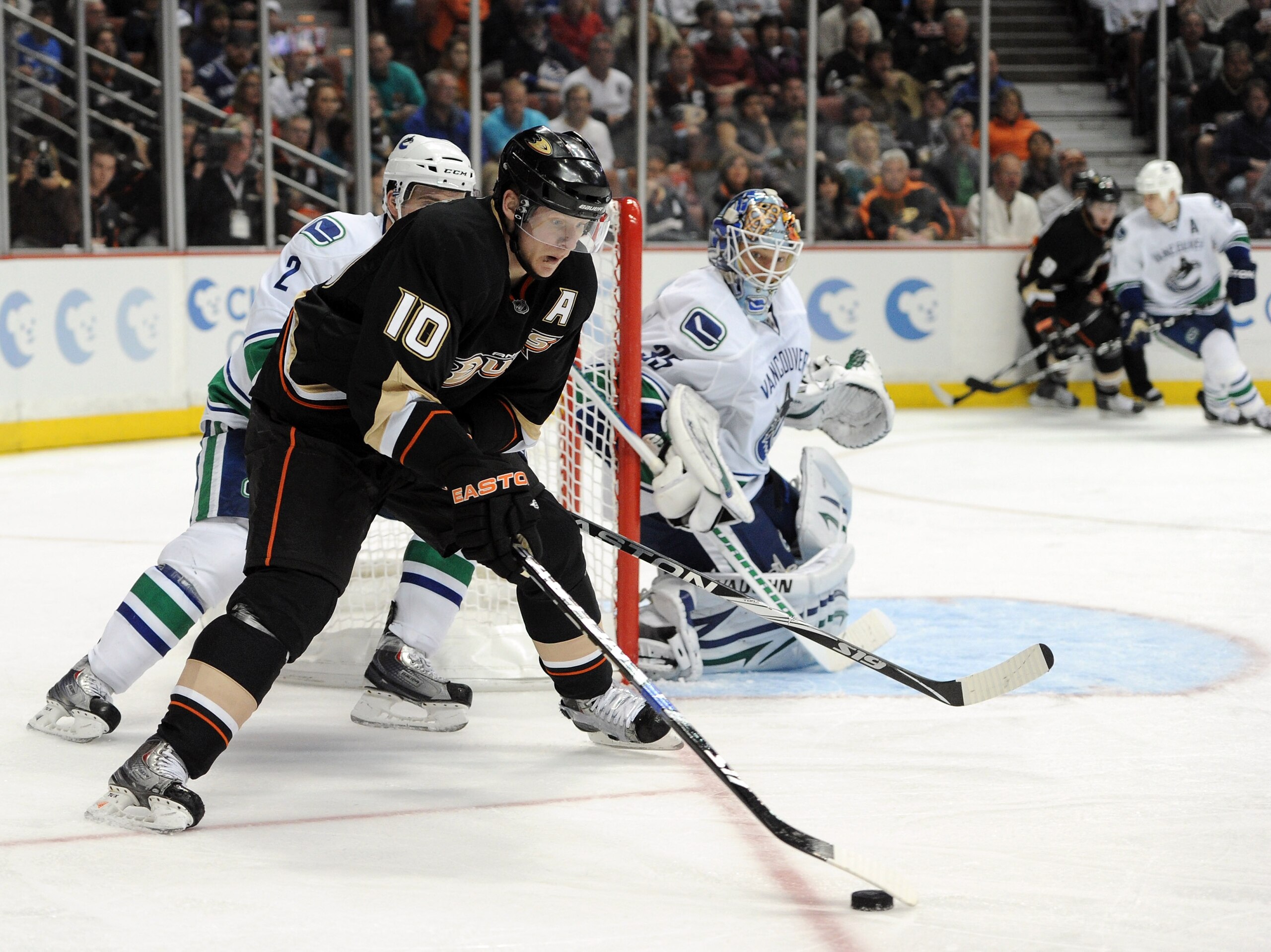 ANAHEIM, CA - MARCH 06:  Cory Schneider #35 of the Vancouver Canucks watches Corey Perry #10 of the Anaheim Ducks as he skates from behind the net at the Honda Center on March 6, 2011 in Anaheim, California.  (Photo by Harry How/Getty Images)