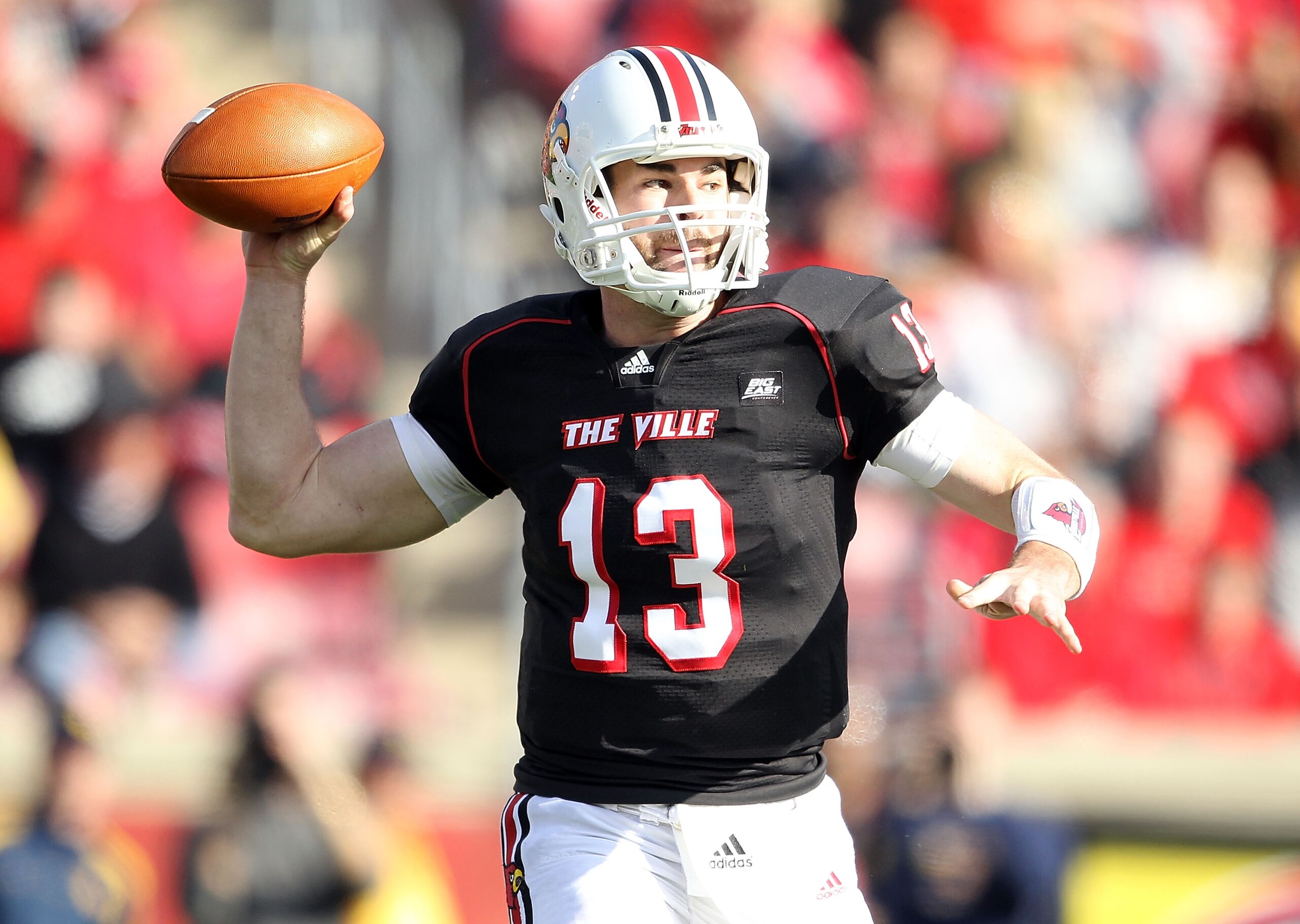 LOUISVILLE, KY - NOVEMBER 20:  Justin Burke #13 of the Louisville Cardinals throws the ball during the Big East Conference game against the West Virginia Mountaineers at Papa John's Cardinal Stadium on November 20, 2010 in Louisville, Kentucky.  (Photo by