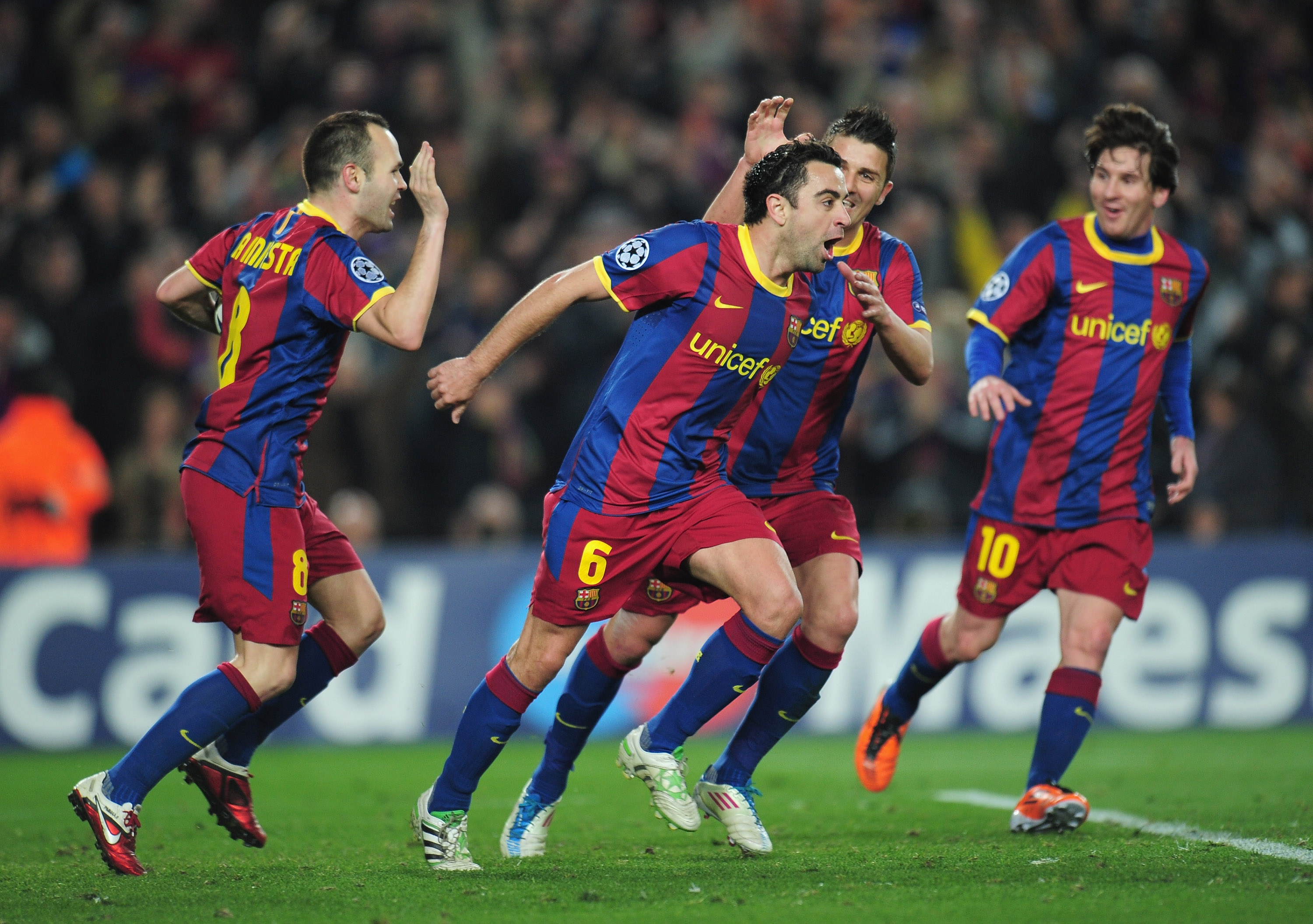 BARCELONA, SPAIN - MARCH 08:  Xavi Hernandez of Barcelona celebrates with team-mates David Villa and Andres Iniesta during the UEFA Champions League round of 16 second leg match between Barcelona and Arsenal at the Nou Camp Stadium on March 8, 2011 in Bar