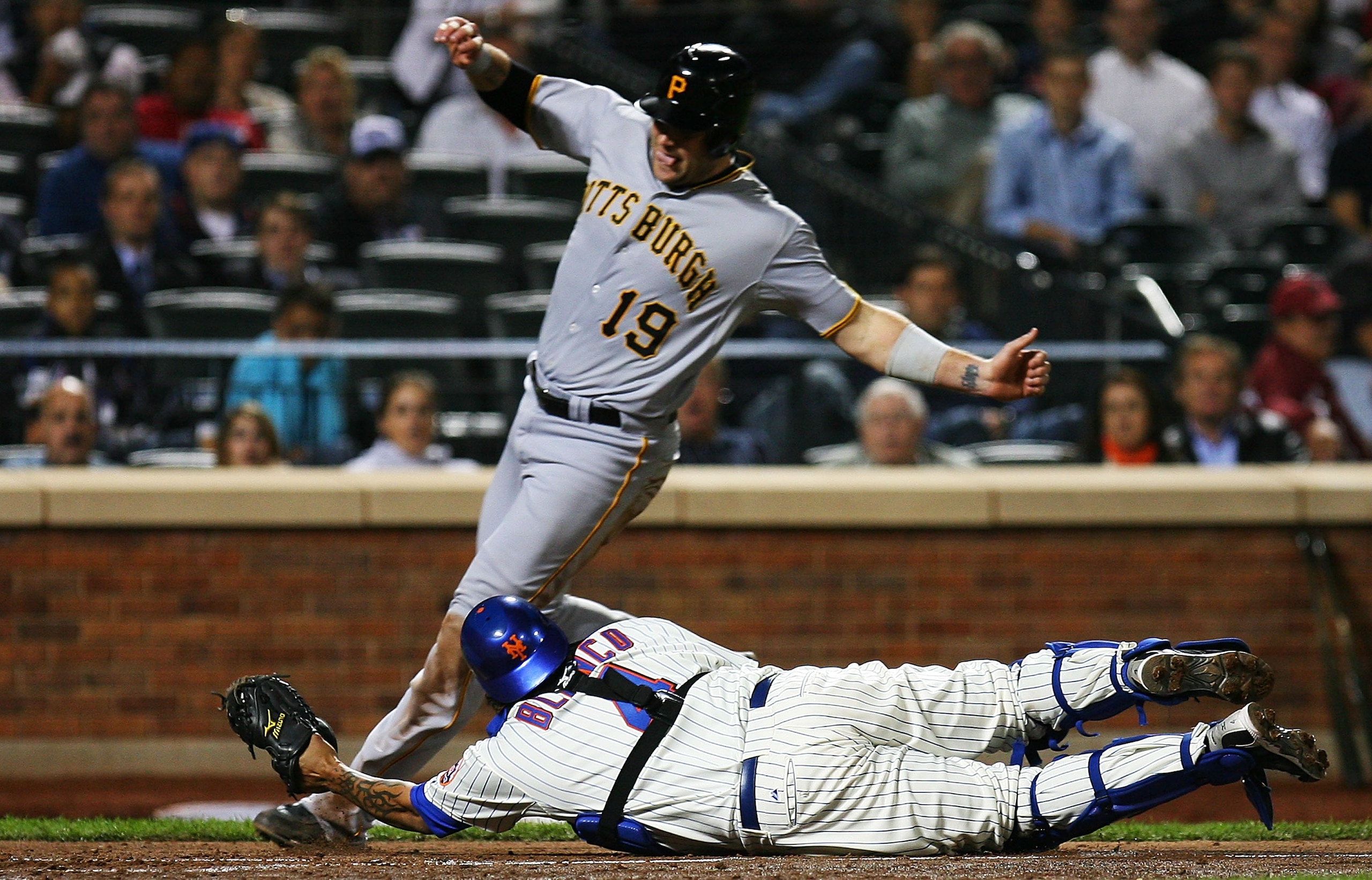NEW YORK - SEPTEMBER 15:  Henry Blanco #4 of the New York Mets is unable to tag Chris Snyder #19 of the Pittsburgh Pirates, who ran in a two run double hit by Andrew McCutchen (not seen) in the fourth inning on September 15, 2010 at Citi Field in the Flus