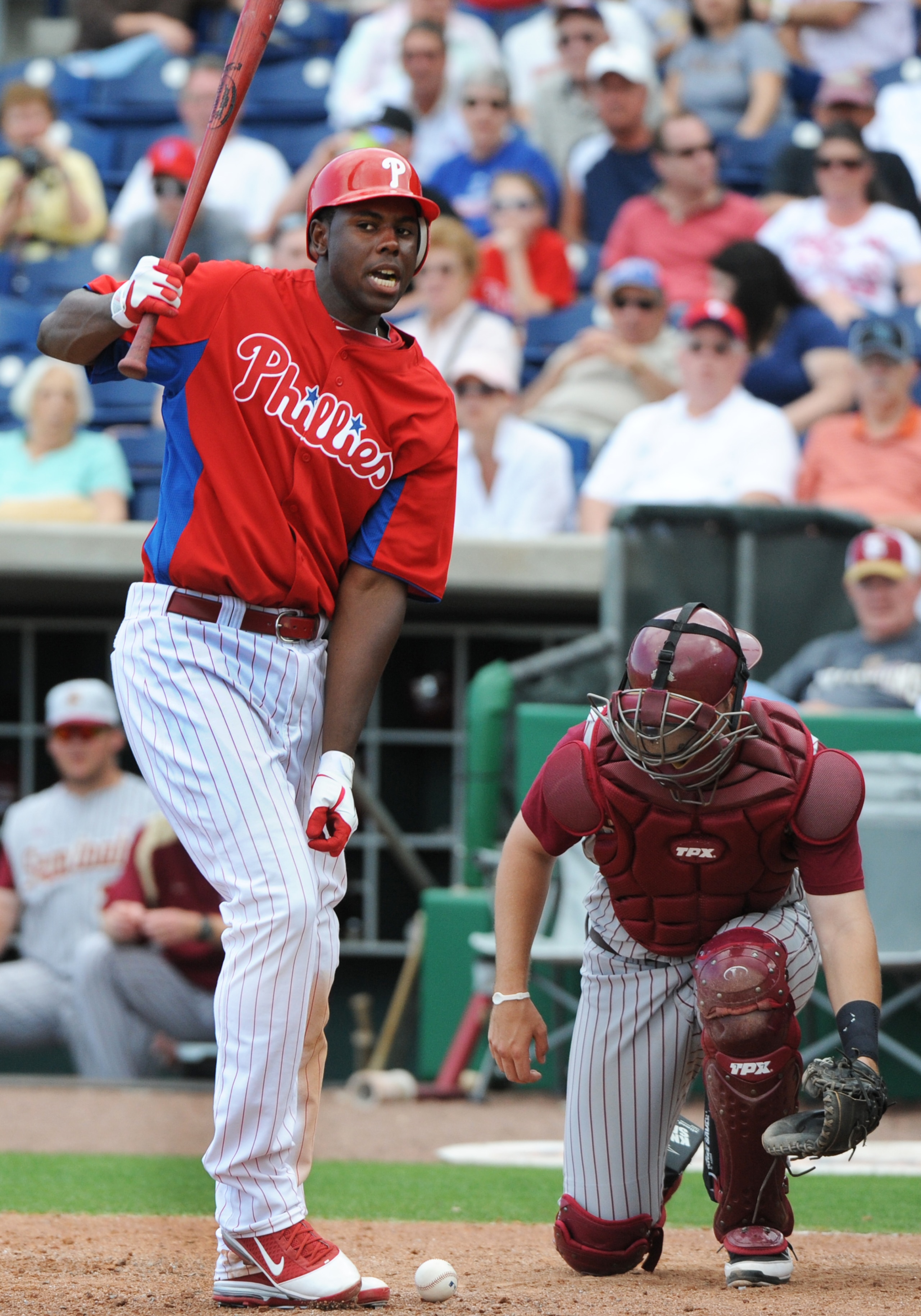 CLEARWATER, FL - FEBRUARY 24:  Outfielder John Mayberry Jr. #15 of the Philadelphia Phillies turns after he is hit by an inside pitch against the Florida State Seminoles February 24, 2011 at Bright House Field in Clearwater, Florida.  (Photo by Al Messers