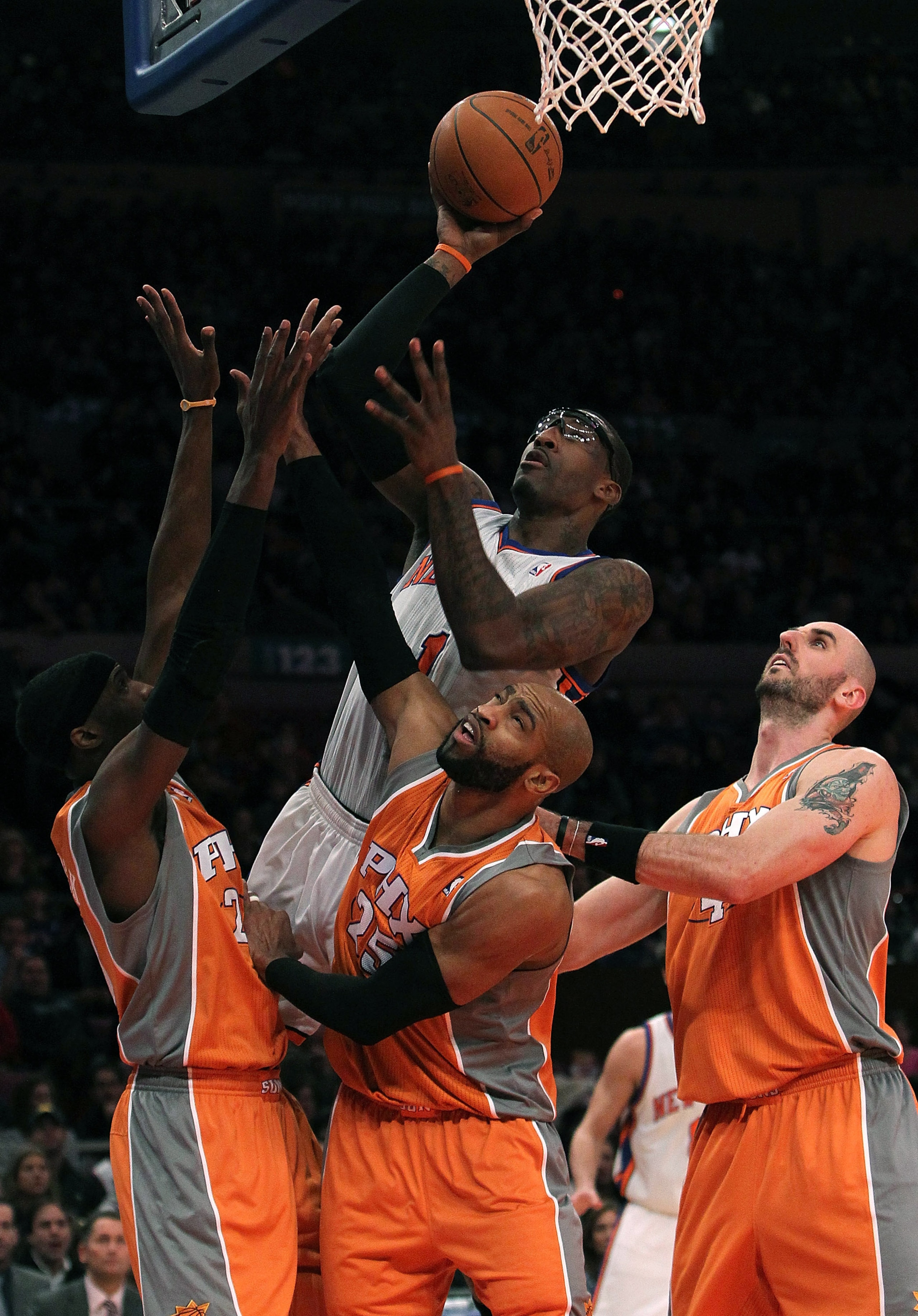 NEW YORK, NY - JANUARY 17:  Amar'e Stoudemire #1 of the New York Knicks shoots the ball against Hakim Warrick #21, Vince Carter #15 and Marcin Gortat #4 of the Phoenix Suns at Madison Square Garden on January 17, 2011 in New York City. NOTE TO USER: User