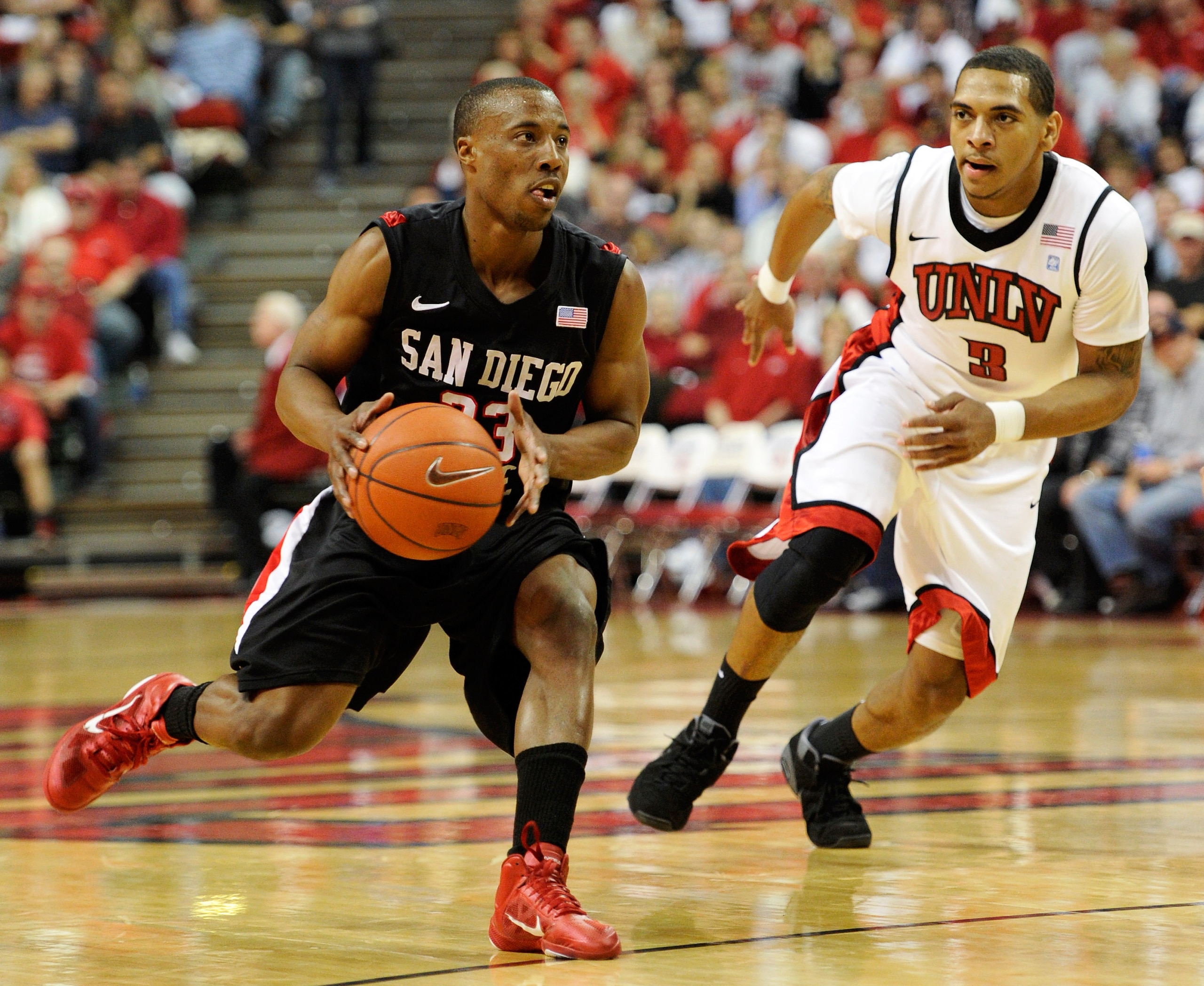 LAS VEGAS, NV - FEBRUARY 12:  D.J. Gay #23 of the San Diego State Aztecs drives against Anthony Marshall #3 of the UNLV Rebels during their game at the Thomas & Mack Center February 12, 2011 in Las Vegas, Nevada. San Diego State won 63-57.  (Photo by Etha