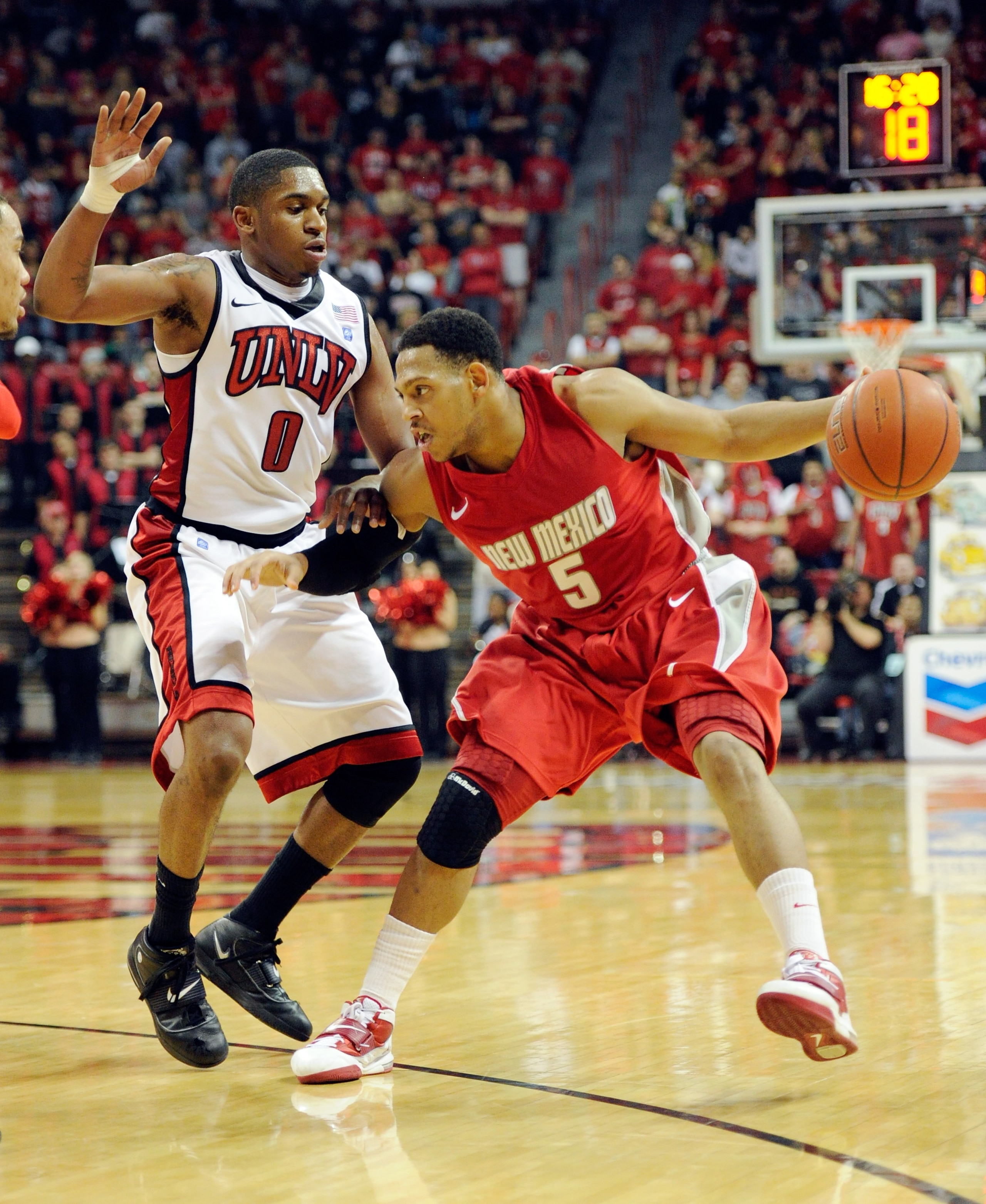 LAS VEGAS, NV - JANUARY 22:  Dairese Gary #5 of the New Mexico Lobos drives against Oscar Bellfield #0 of the UNLV Rebels during their game at the Thomas & Mack Center January 22, 2011 in Las Vegas, Nevada. UNLV won 63-62.  (Photo by Ethan Miller/Getty Im
