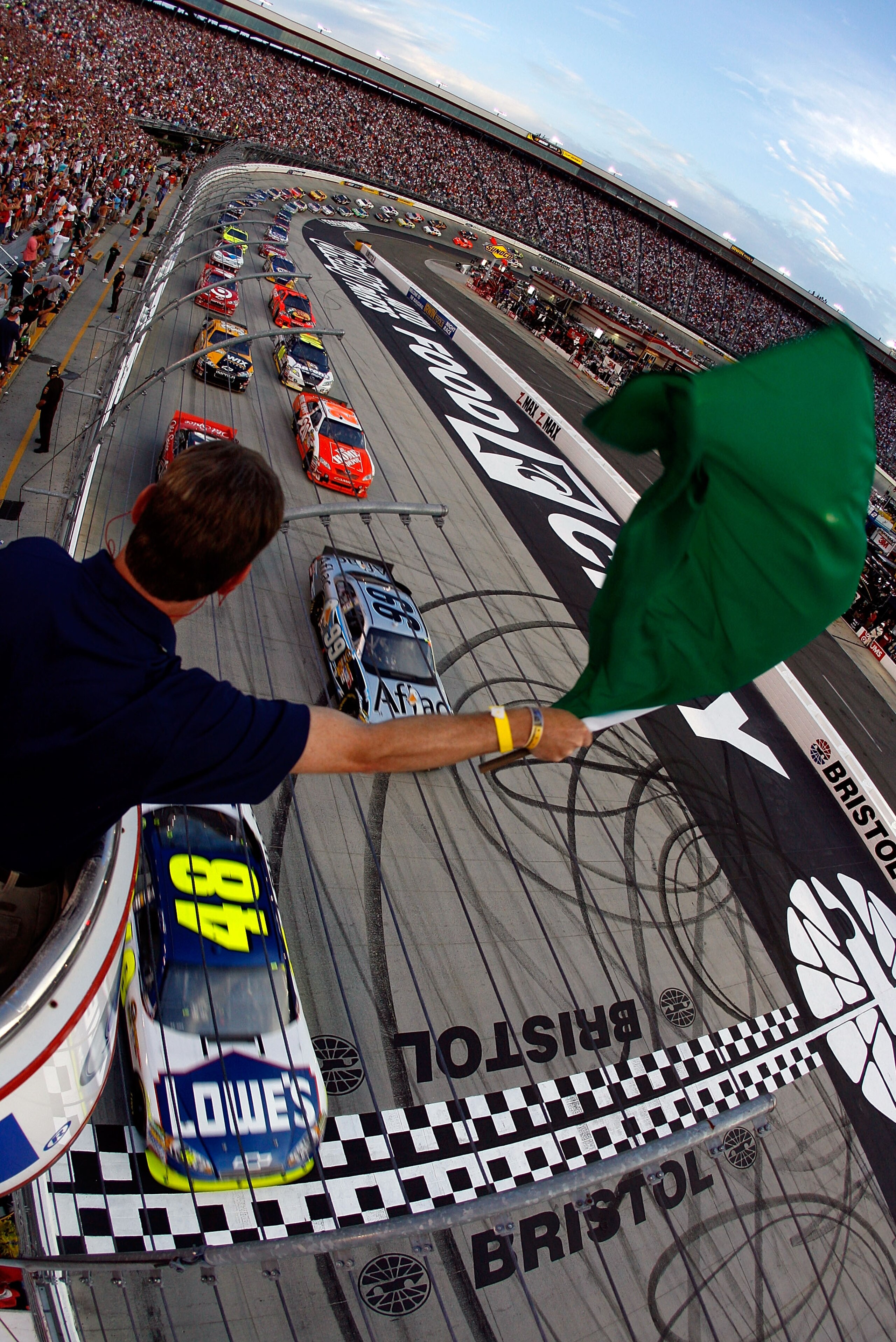 BRISTOL, TN - AUGUST 21: Jimmie Johnson, driver of the #48 Lowe's Chevrolet, and Carl Edwards, driver of the #99 Aflac Ford, take the green flag to start the NASCAR Sprint Cup Series IRWIN Tools Night Race at Bristol Motor Speedway on August 21, 2010 in BRISTOL, TN - AUGUST 21: Jimmie Johnson, driver of the #48 Lowe's Chevrolet, and Carl Edwards, driver of the #99 Aflac Ford, take the green flag to start the NASCAR Sprint Cup Series IRWIN Tools Night Race at Bristol Motor Speedway on August 21, 2010 in