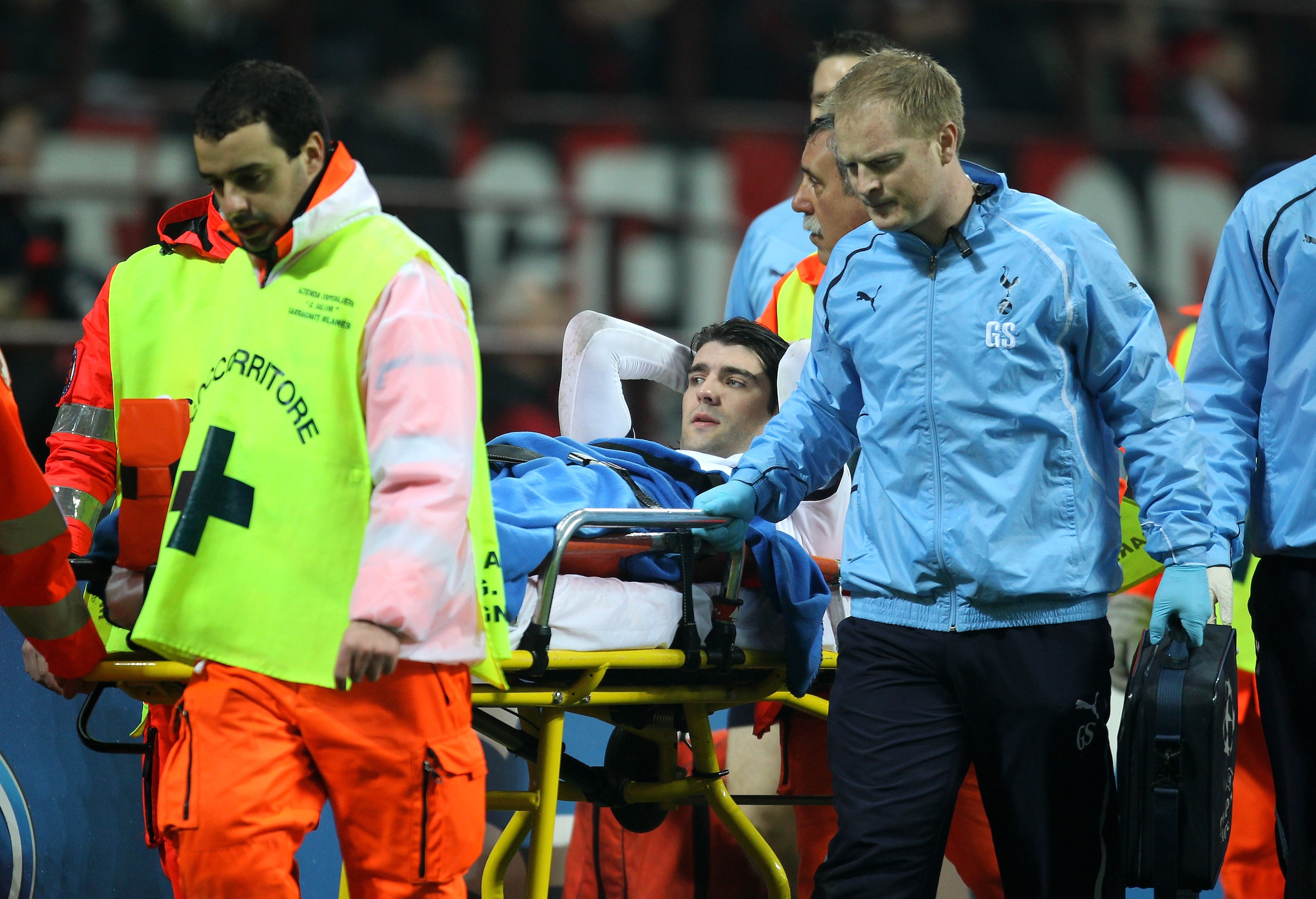 MILAN, ITALY - FEBRUARY 15:  Vedran Corluka of Tottenham Hotspur is stretchered off following a challenge by Mathieu Flamini of AC Milan during the UEFA Champions League round of 16 first leg match between AC Milan and Tottenham Hotspur at Stadio Giuseppe