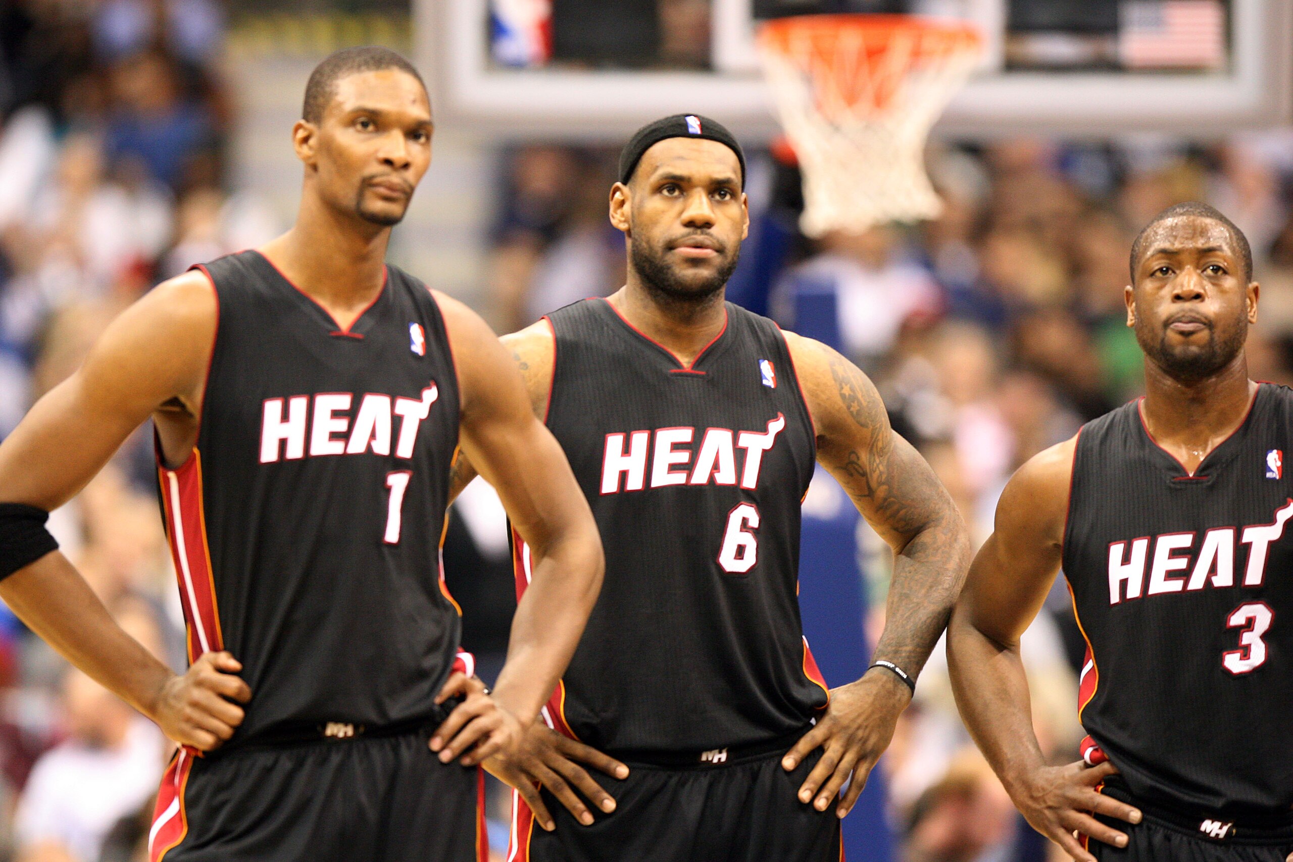 DALLAS - NOVEMBER 27: Chris Bosh #1, 2 #6 and Dwyane Wade #3 of the Miami Heat look on during their game against the Dallas Mavericks  on November 27, 2010 at the American Airlines Center in Dallas, Texas. NOTE TO USER: User expressly acknowledges and agr
