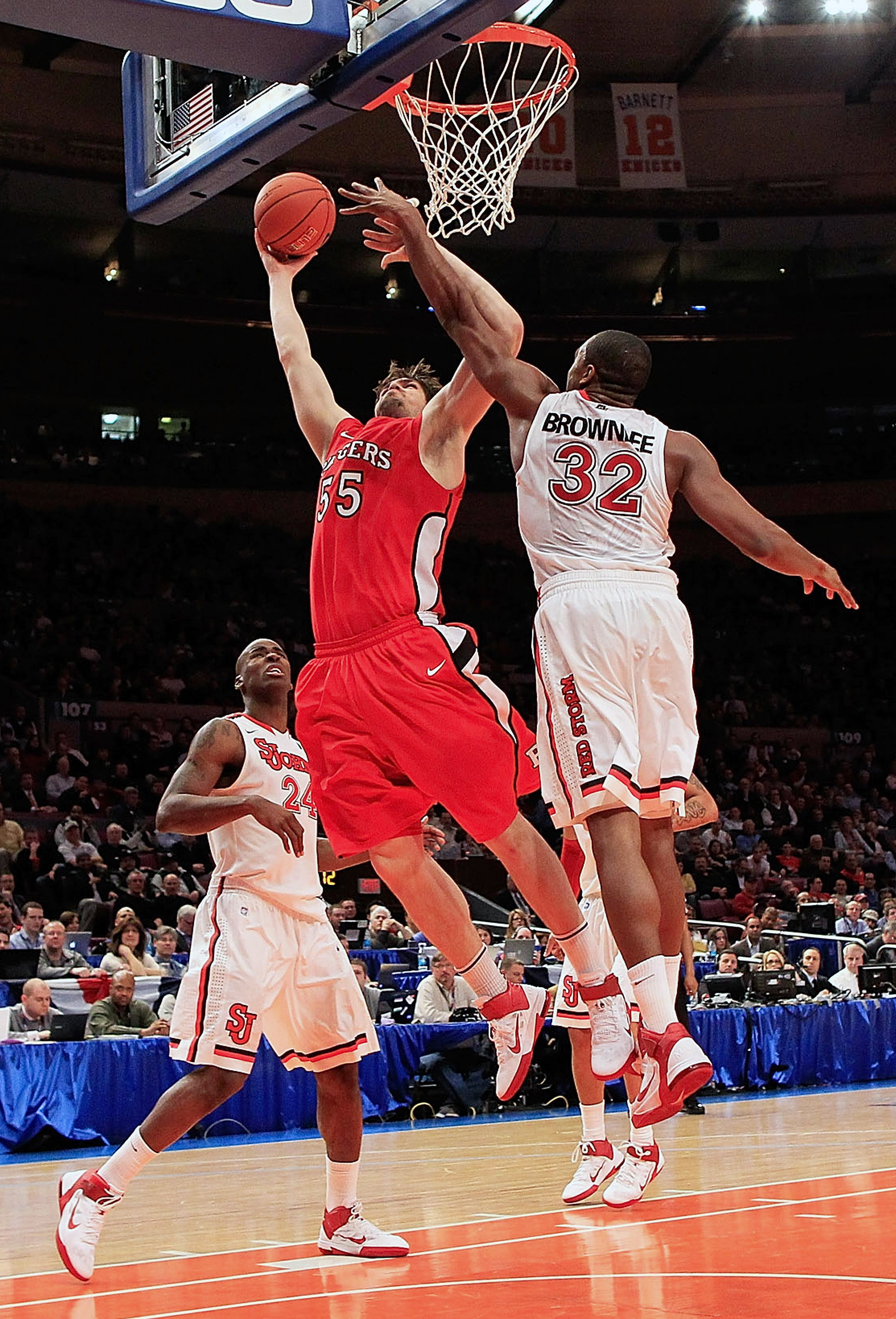 NEW YORK, NY - MARCH 09: Gilvydas Biruta #55 of the Rutgers Scarlet Knights shoots over Justin Brownlee #32 of the St.Johns Red Storm during the second round of the 2011 Big East Men's Basketball Tournament presented by American Eagle Outfitters at Madiso