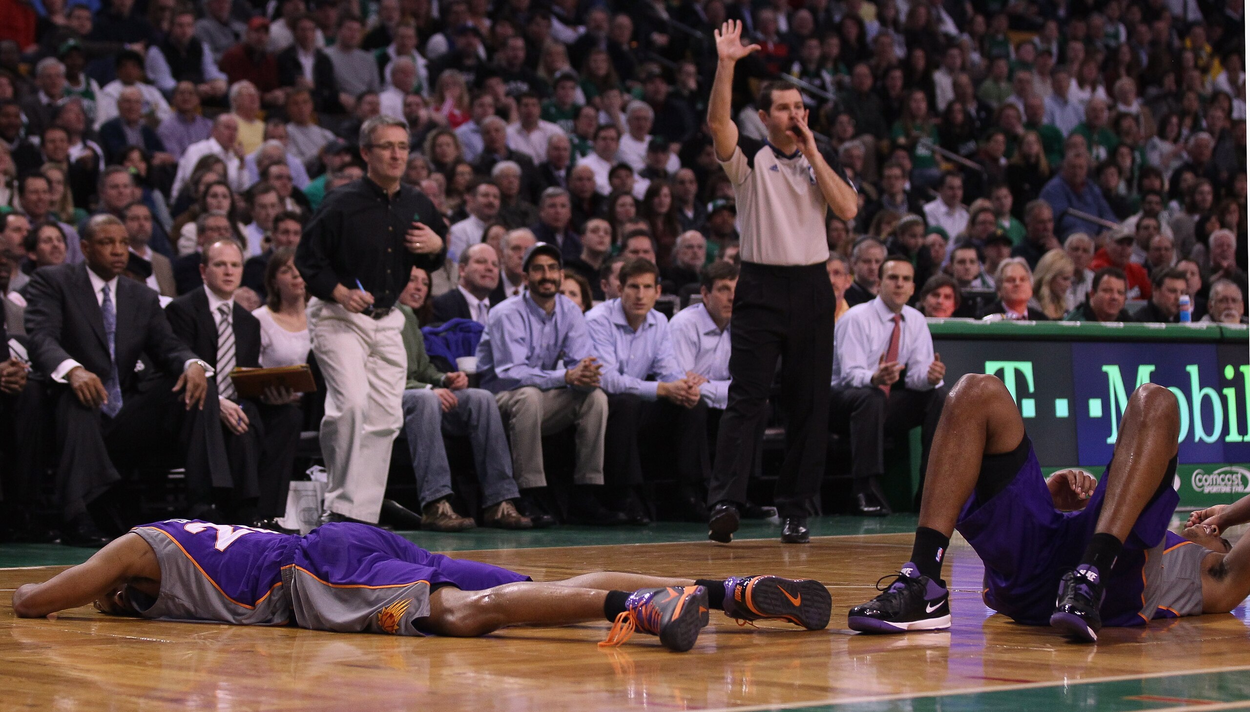 BOSTON, MA - MARCH 02: Vince Carter #25 and Channing Frye #8 of the Phoenix Suns lie on the court after colliding in the second half against the Boston Celtics on March 2, 2011 at the TD Garden in Boston, Massachusetts.  The Celtics defeated the Suns 115-